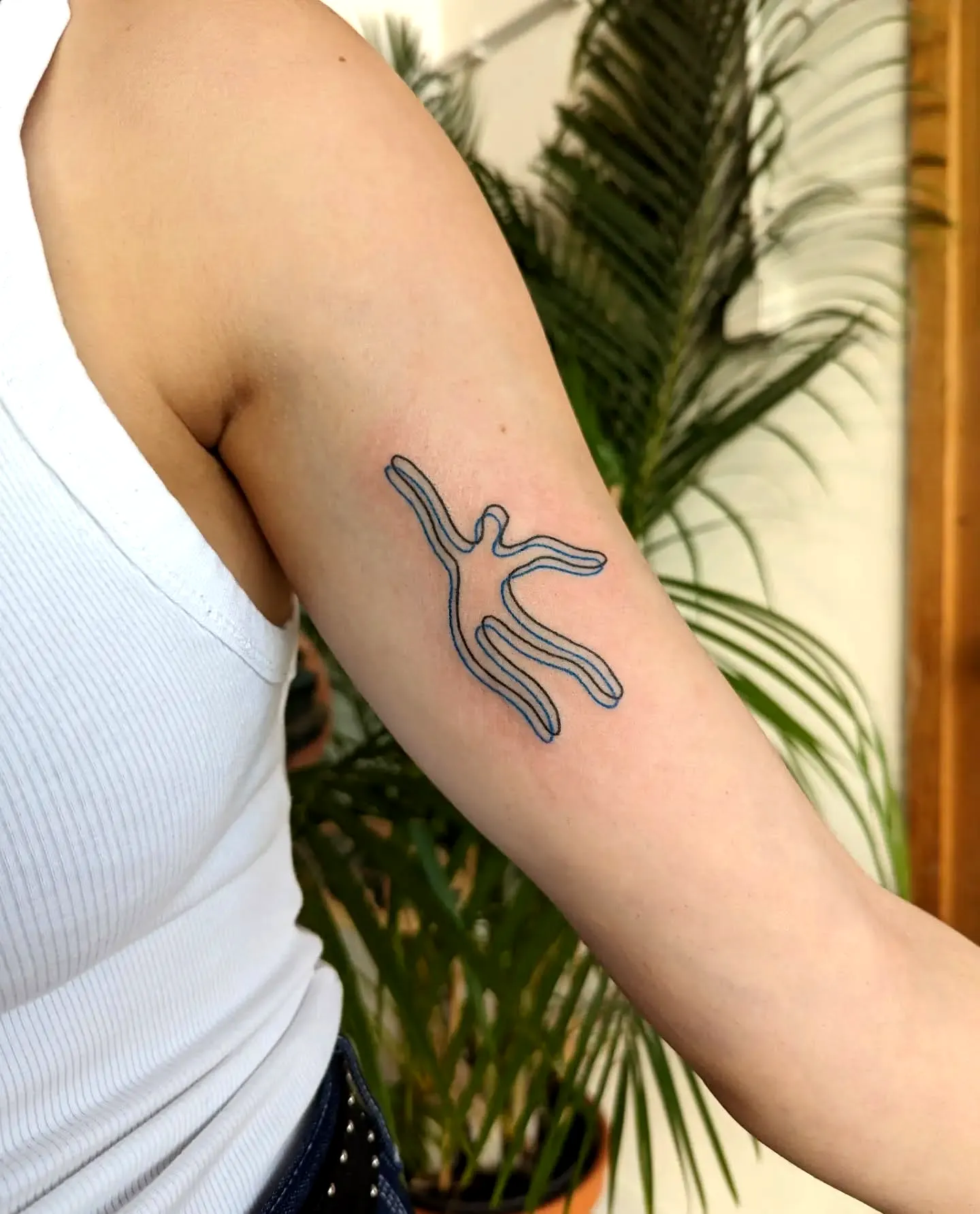 Minimalist Human Figure Arm Tattoo