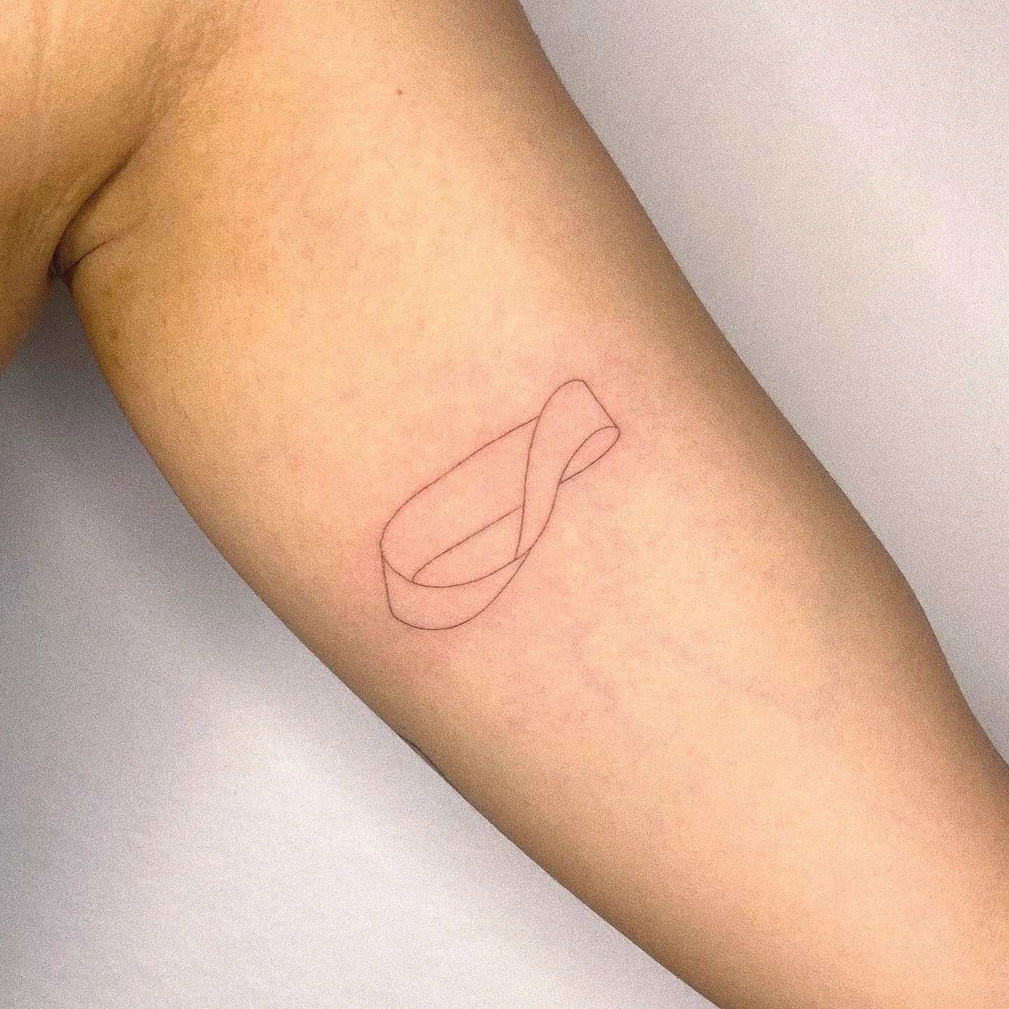 Minimalist Infinity Upper Arm Tattoo