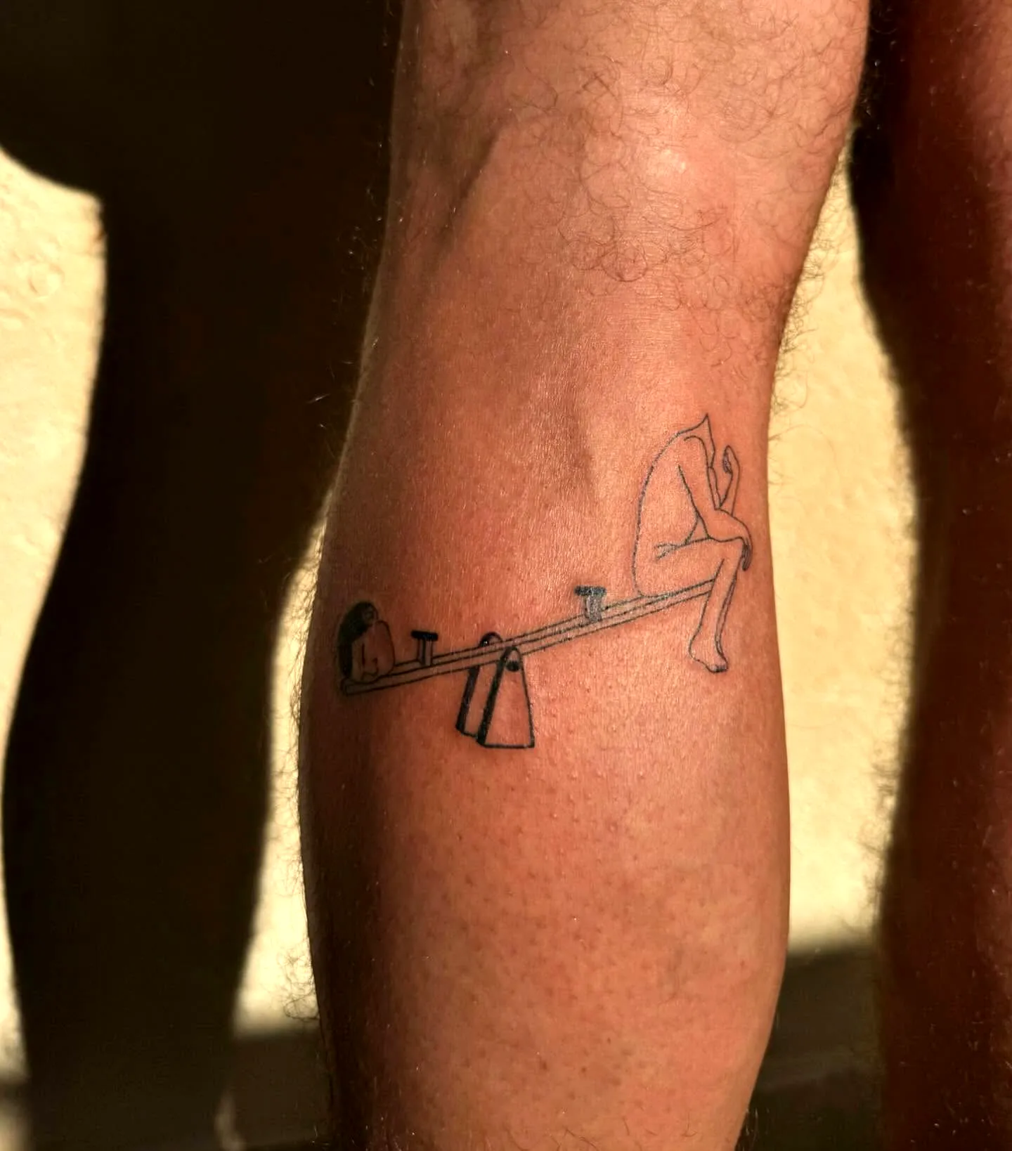 Minimalist Seesaw Leg Tattoo