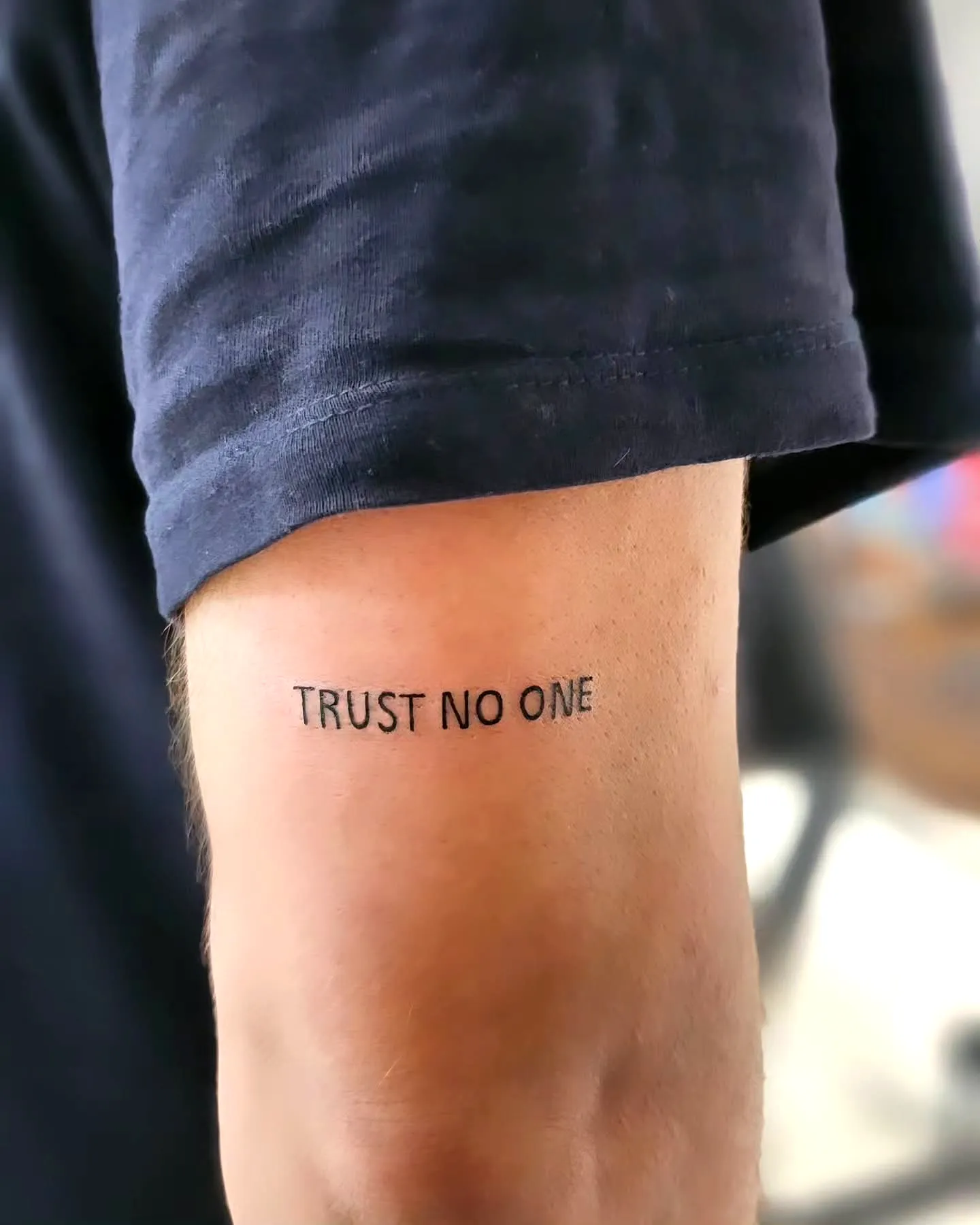 Minimalist Trust Tattoo on Inner Arm