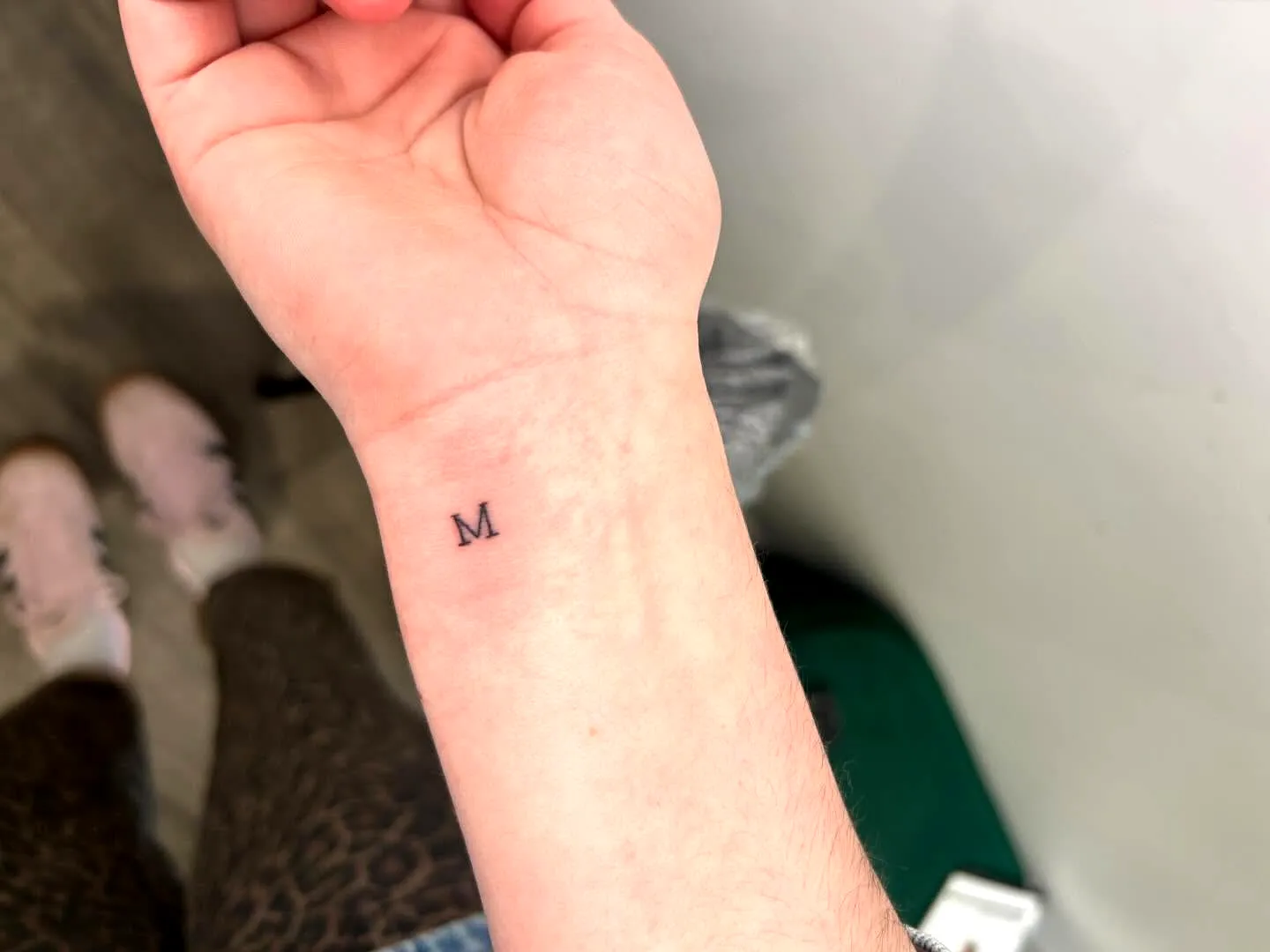 Minimalistic M Wrist Tattoo Design