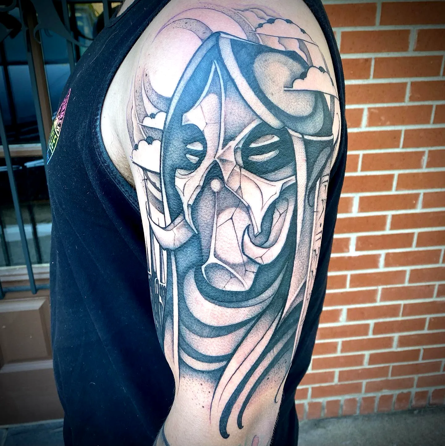 Monochromatic Skull Upper Arm Tattoo