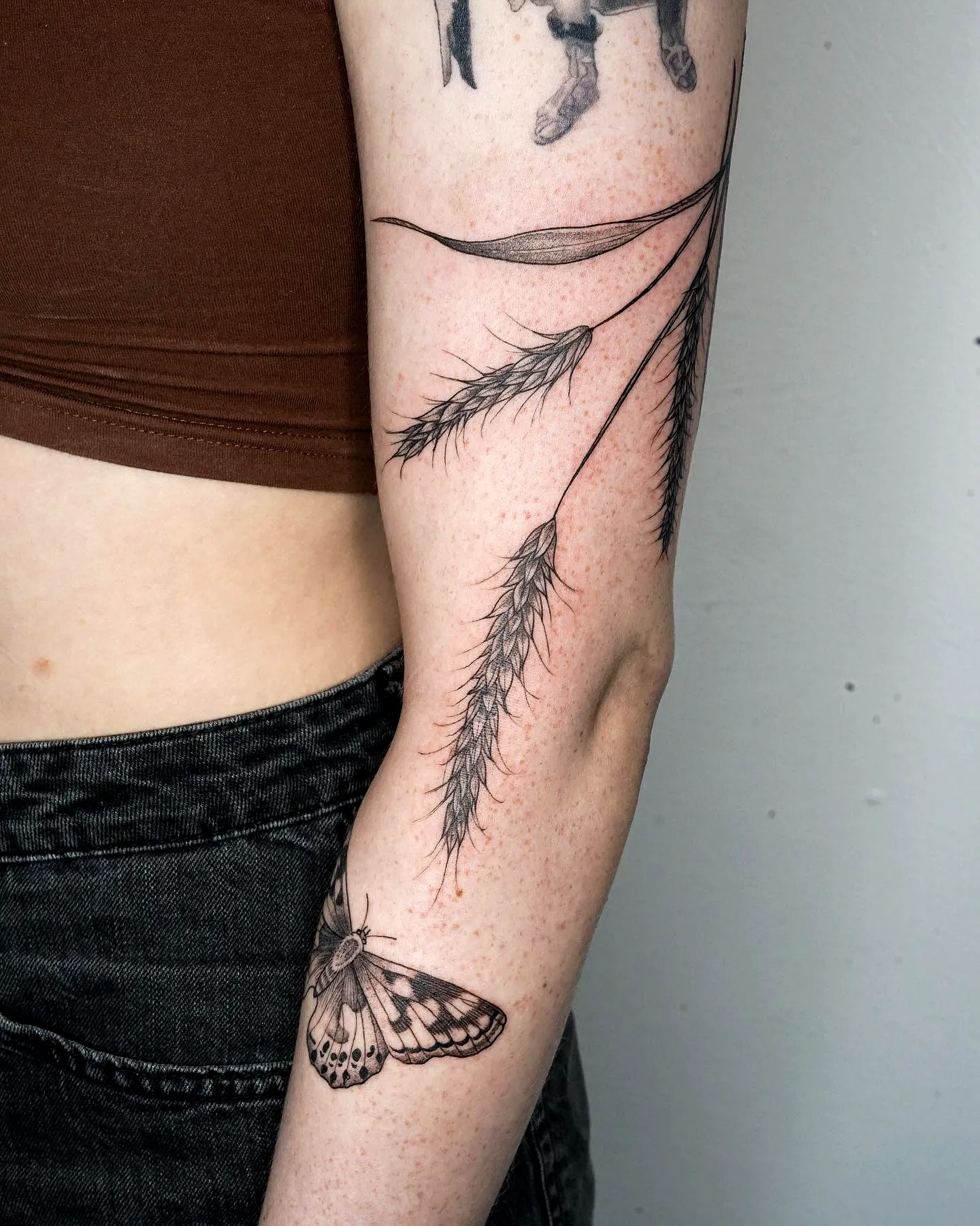 Moth Forearm Tattoo with Leaf Elements