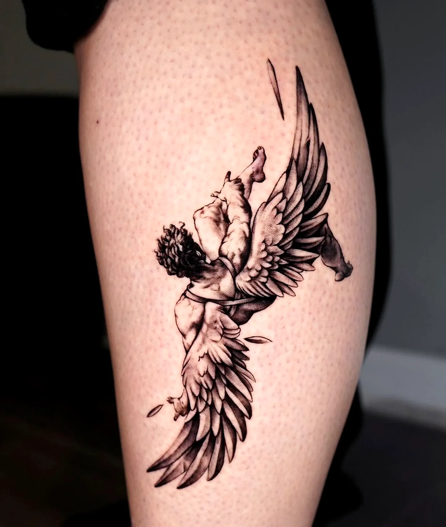 Muscular Angel Thigh Tattoo in Black and Gray