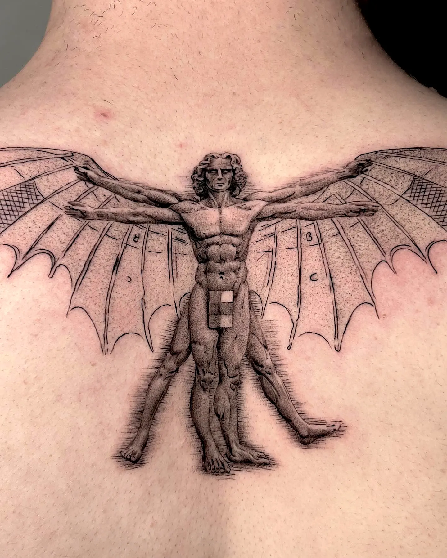 Muscular Bat-Winged Figure Back Tattoo