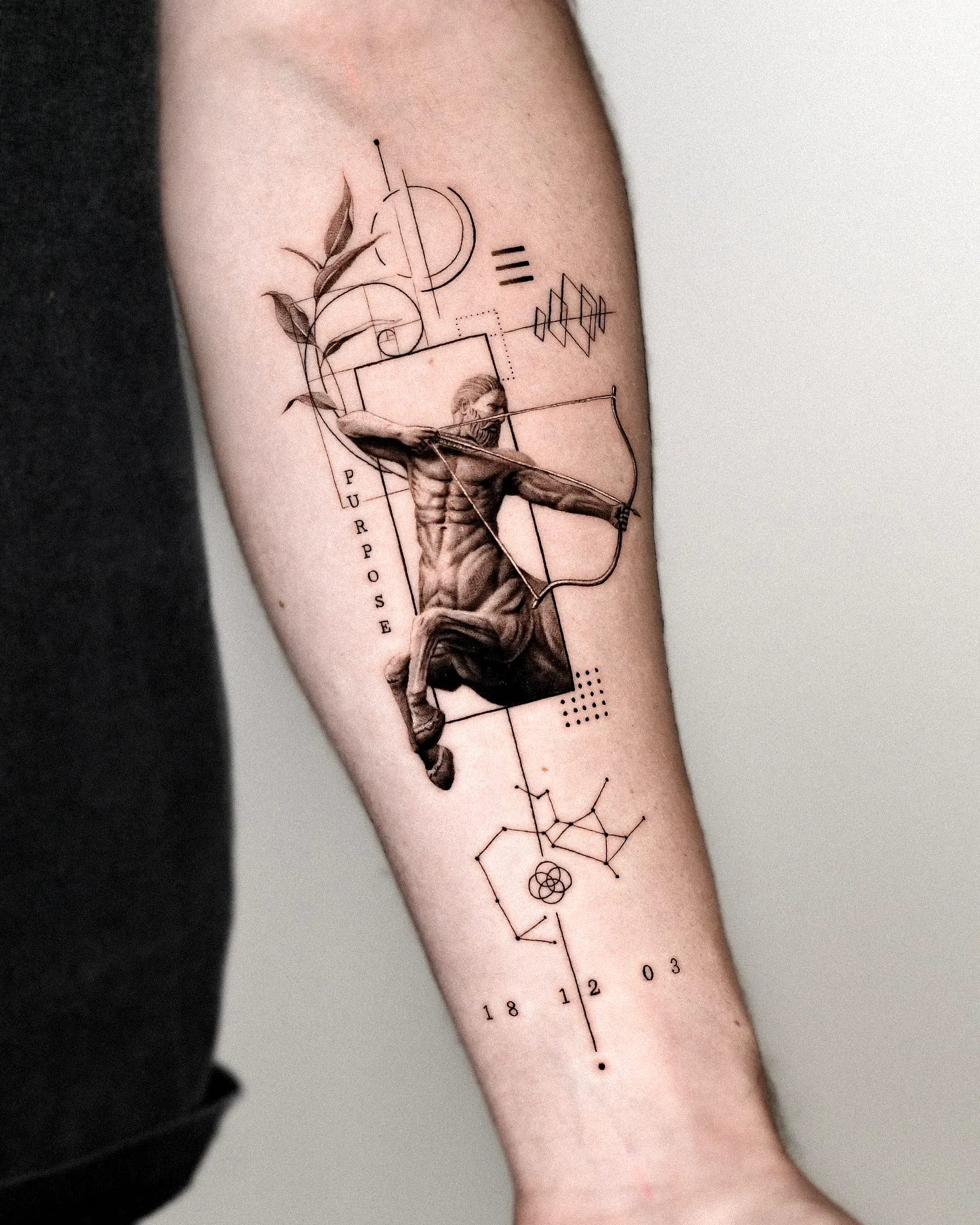 Muscular Forearm Tattoo with Geometric Elements