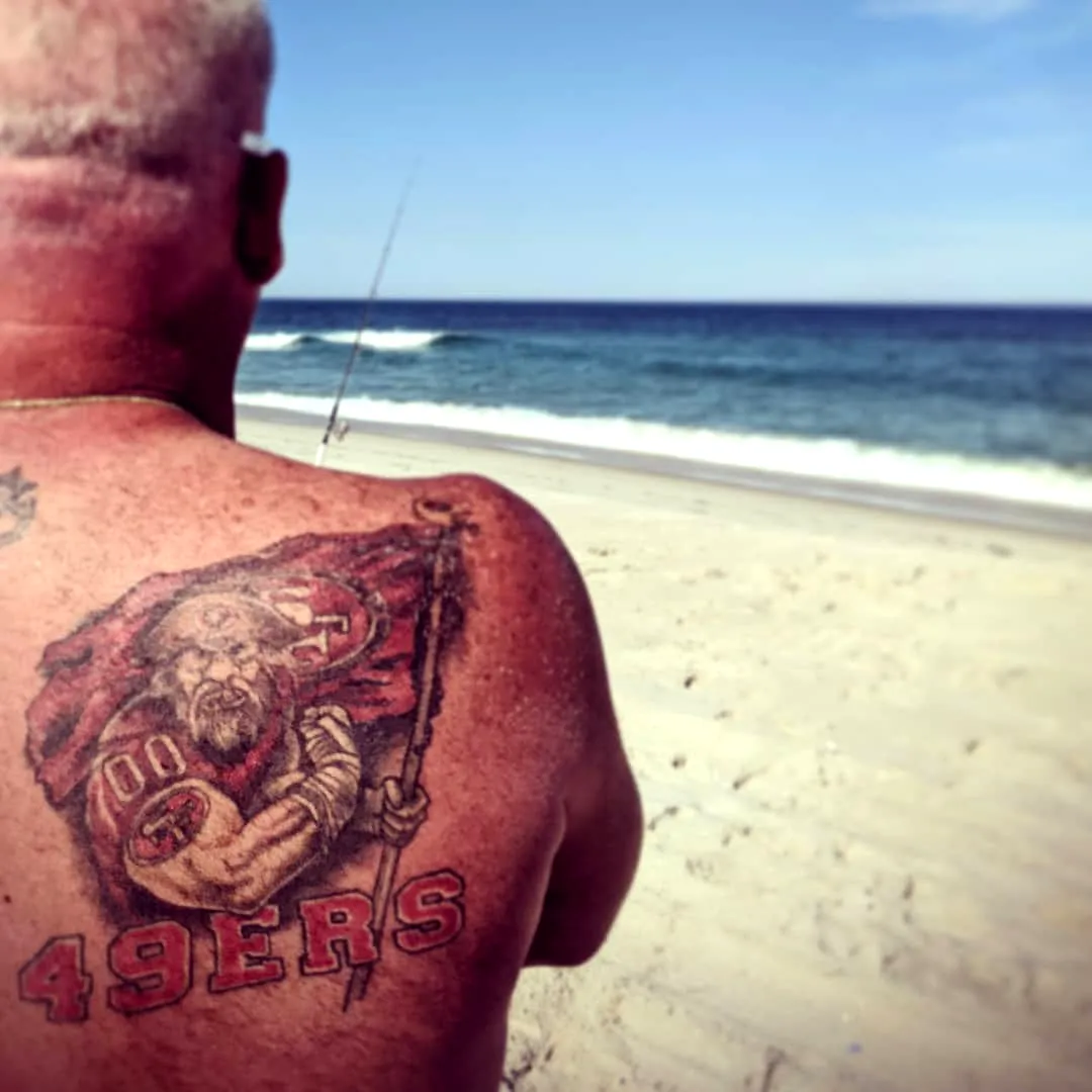 Muscular Man Back Tattoo 49ers Flag Design