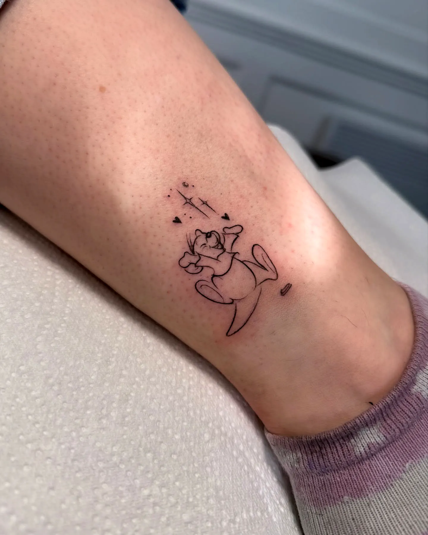 Playful Character Ankle Tattoo