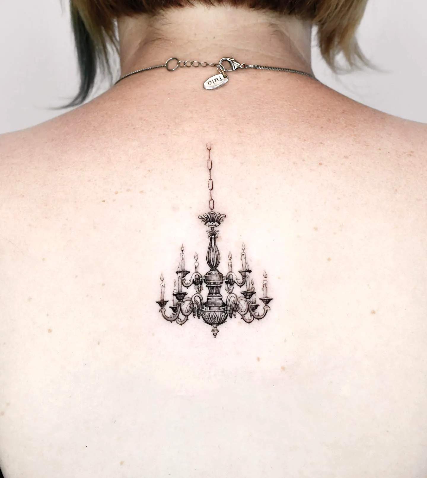 Realistic Chandelier Upper Back Tattoo