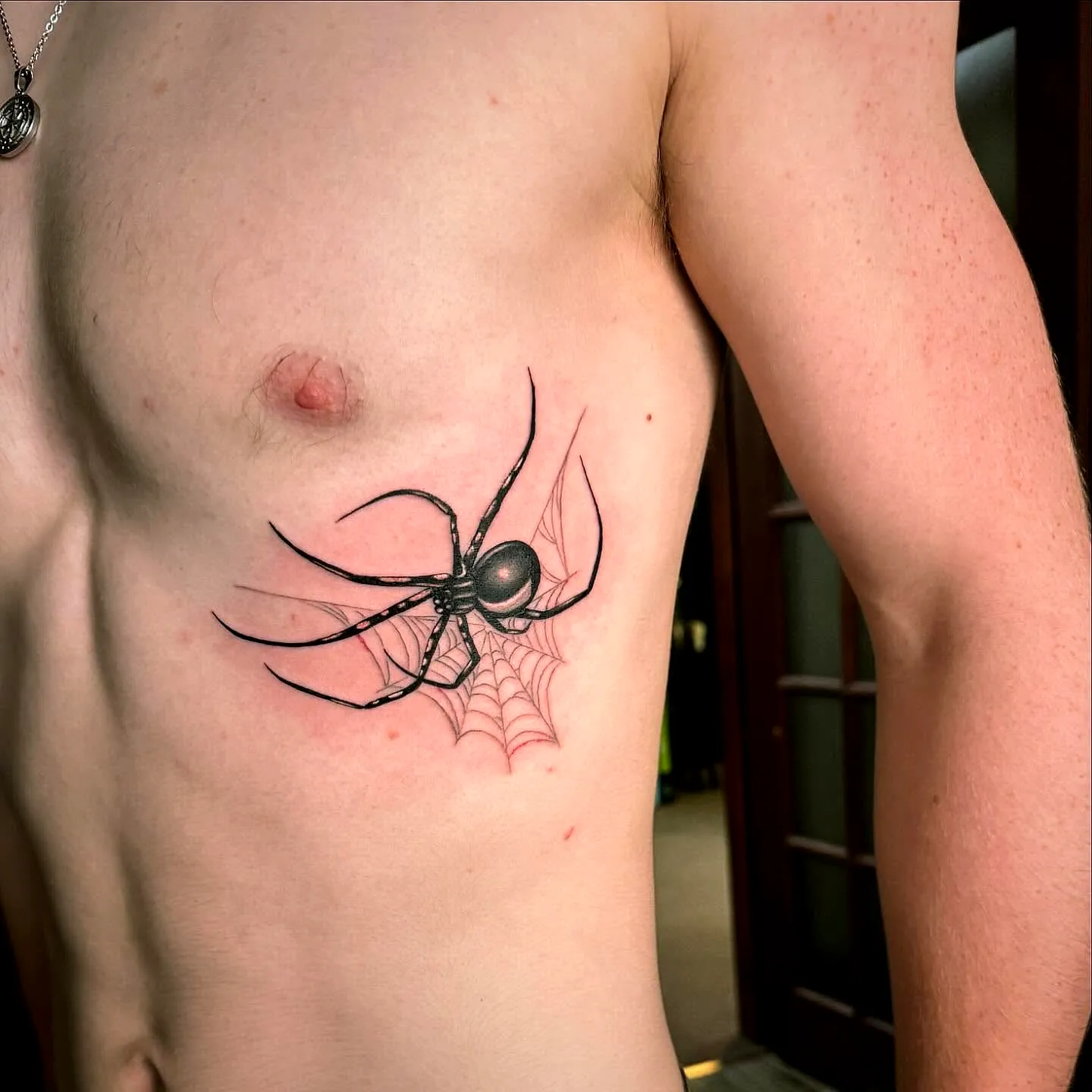 Realistic Spider Ribcage Tattoo with Web