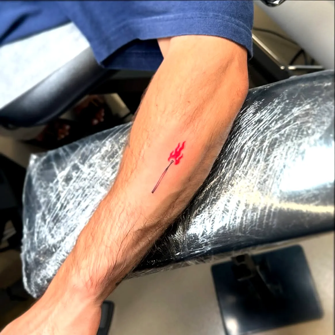 Red Trident Forearm Tattoo