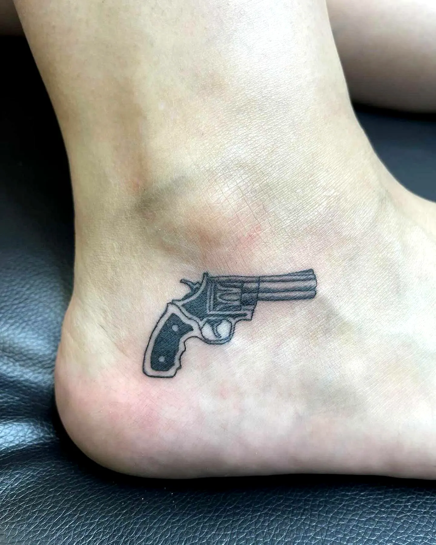 Revolver Ankle Tattoo in Black and Gray