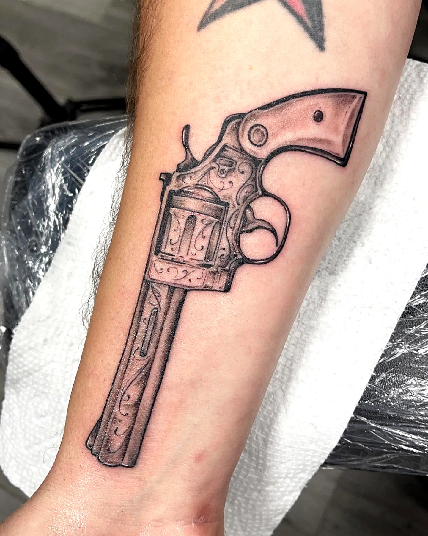 Revolver Forearm Tattoo in Black and Gray