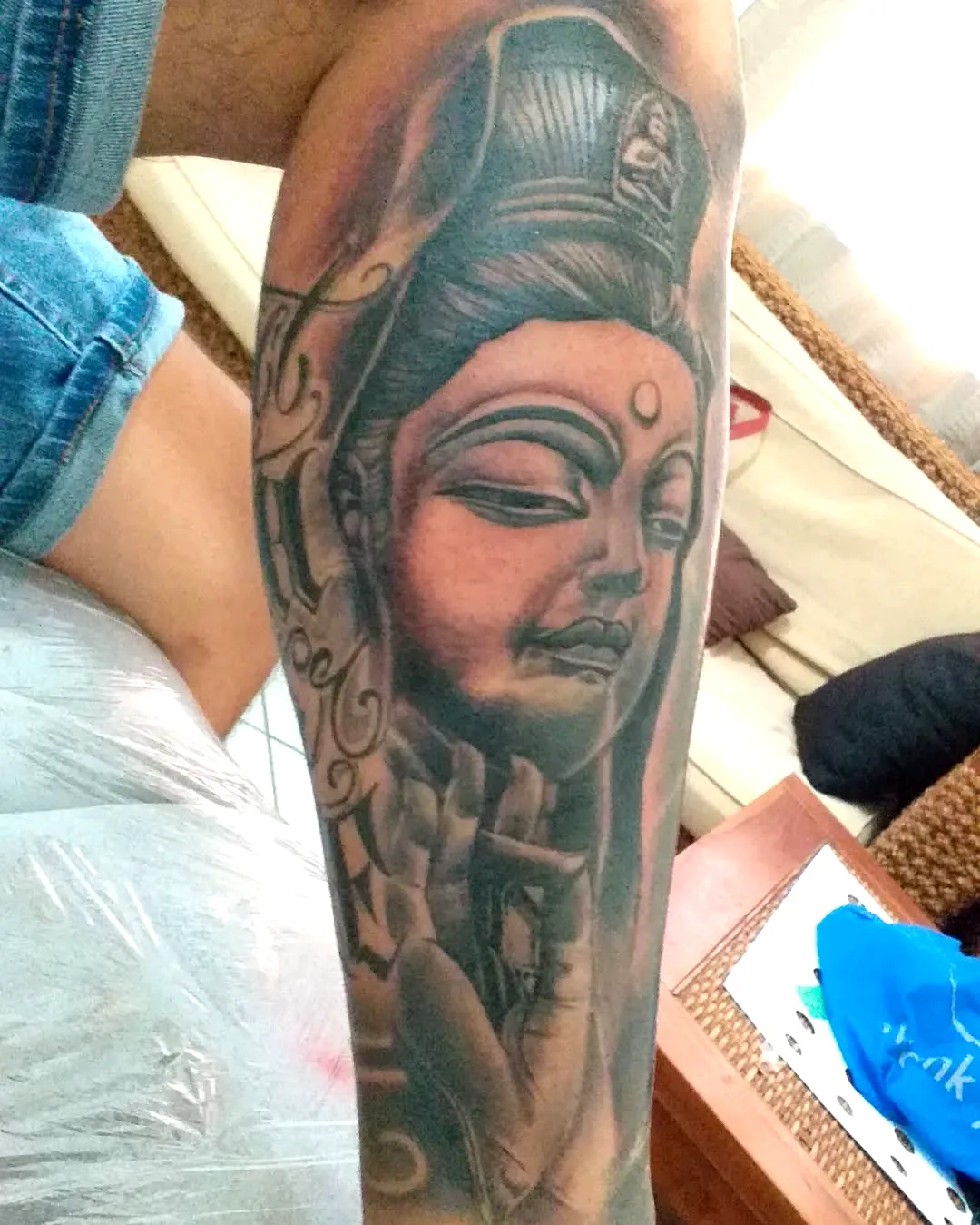 Serene Deity Leg Tattoo in Gray Shades