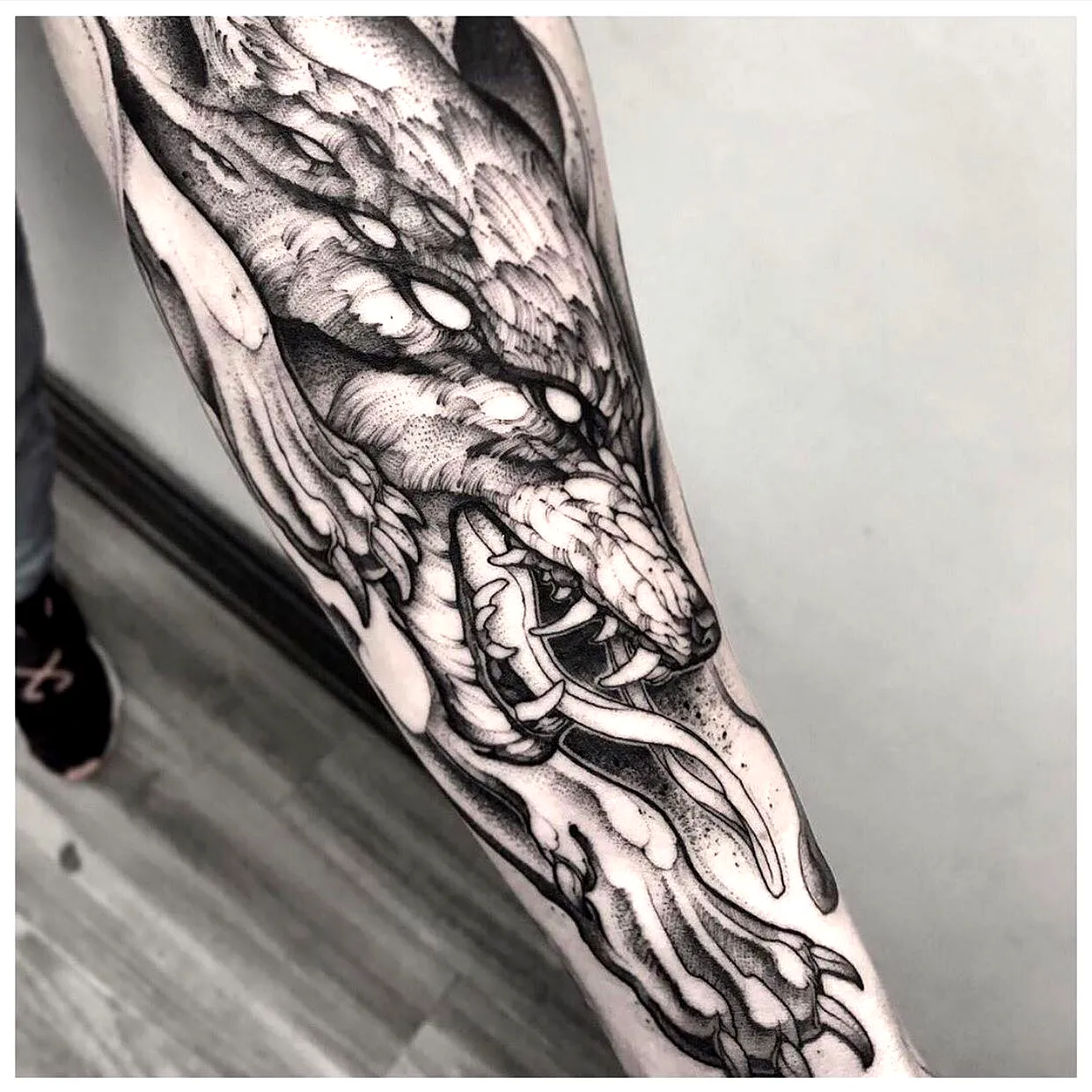 Serpent Arm Tattoo in Black Ink