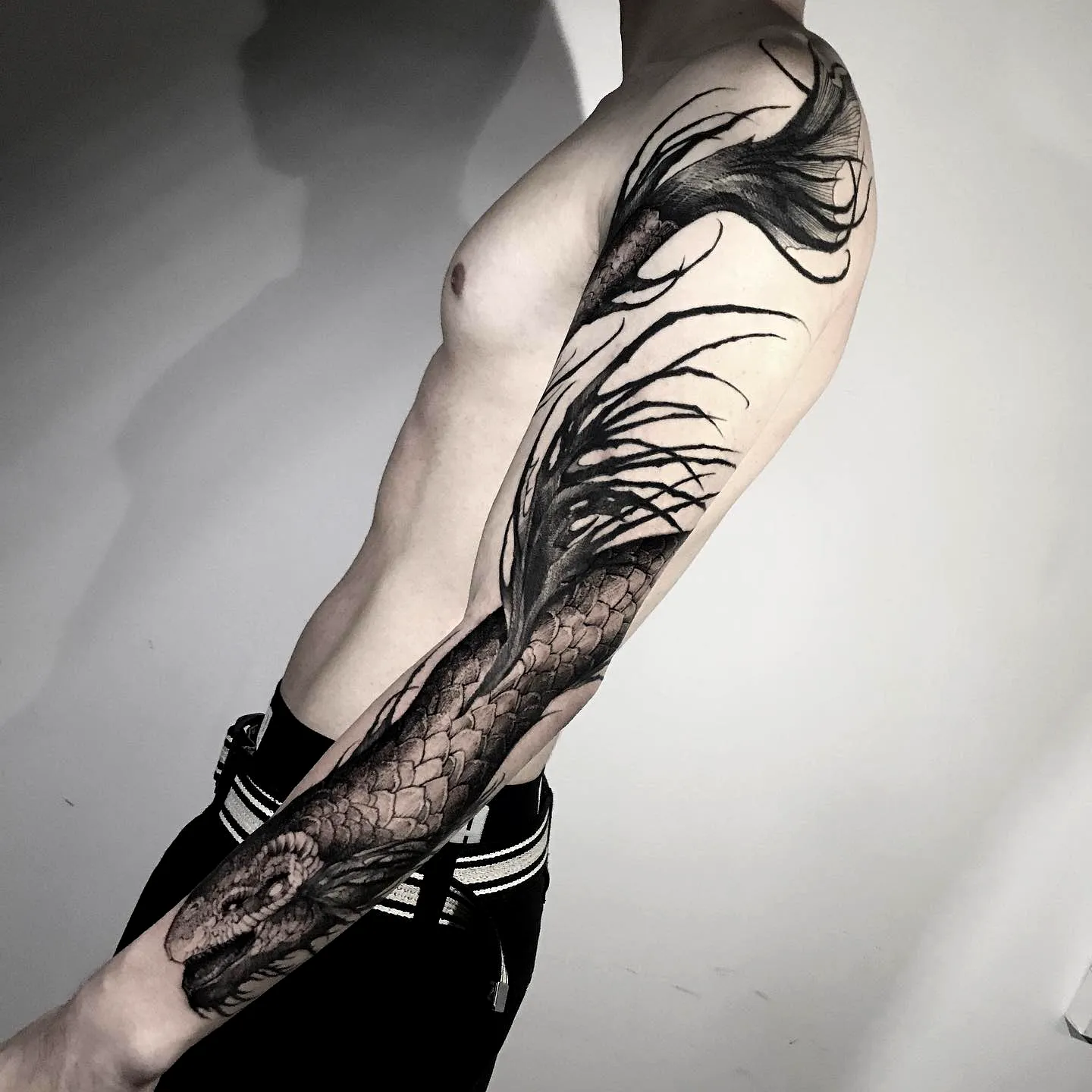 Serpent Forearm Tattoo with Flowing Elements