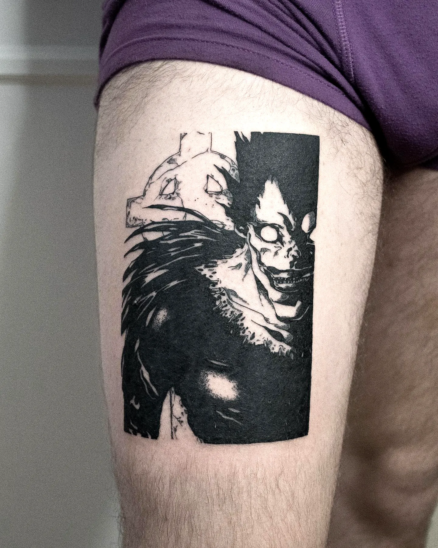 Sharp-featured Ryuk upper thigh tattoo