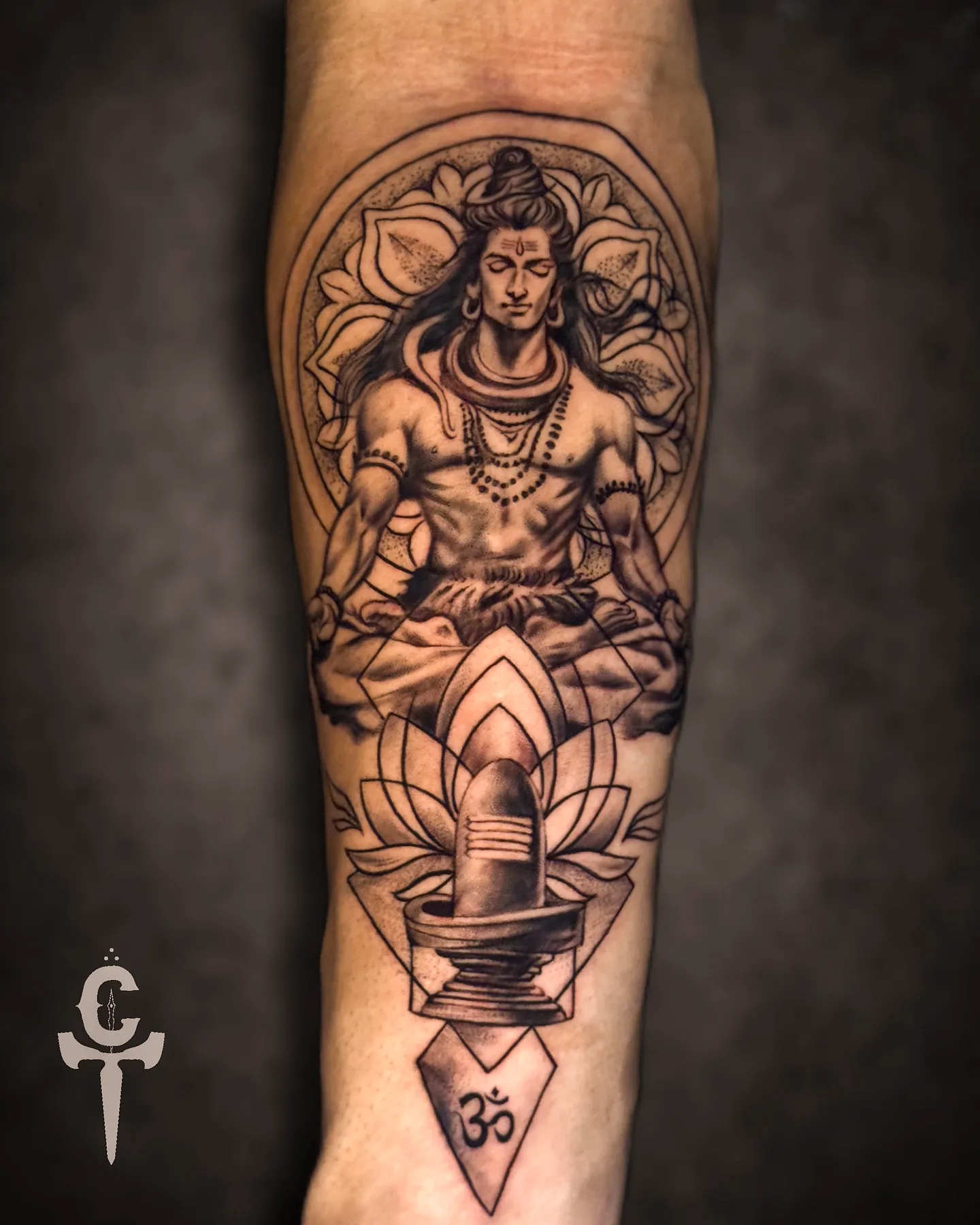 Shiva seated arm tattoo with floral design