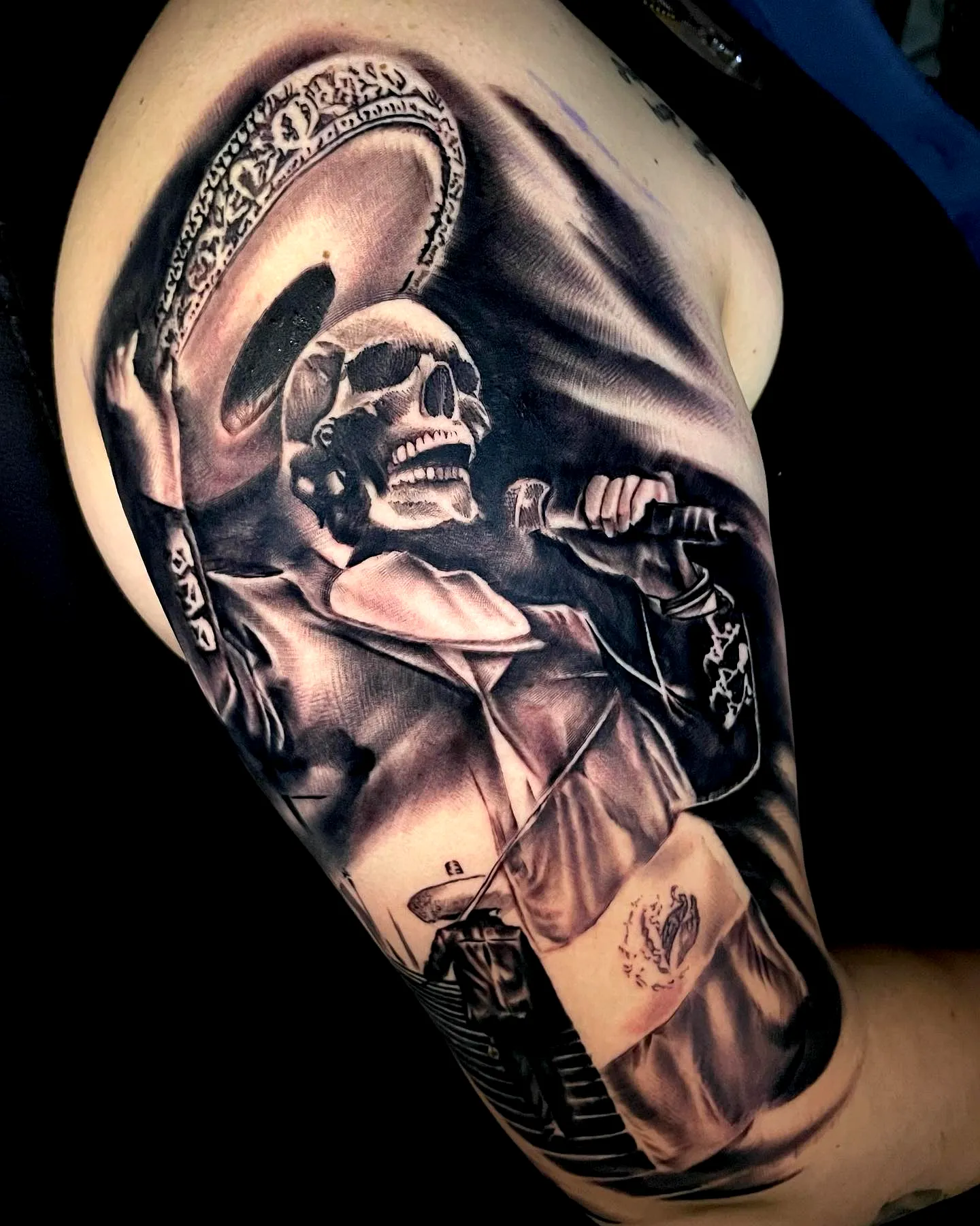 Skeleton mariachi upper arm tattoo