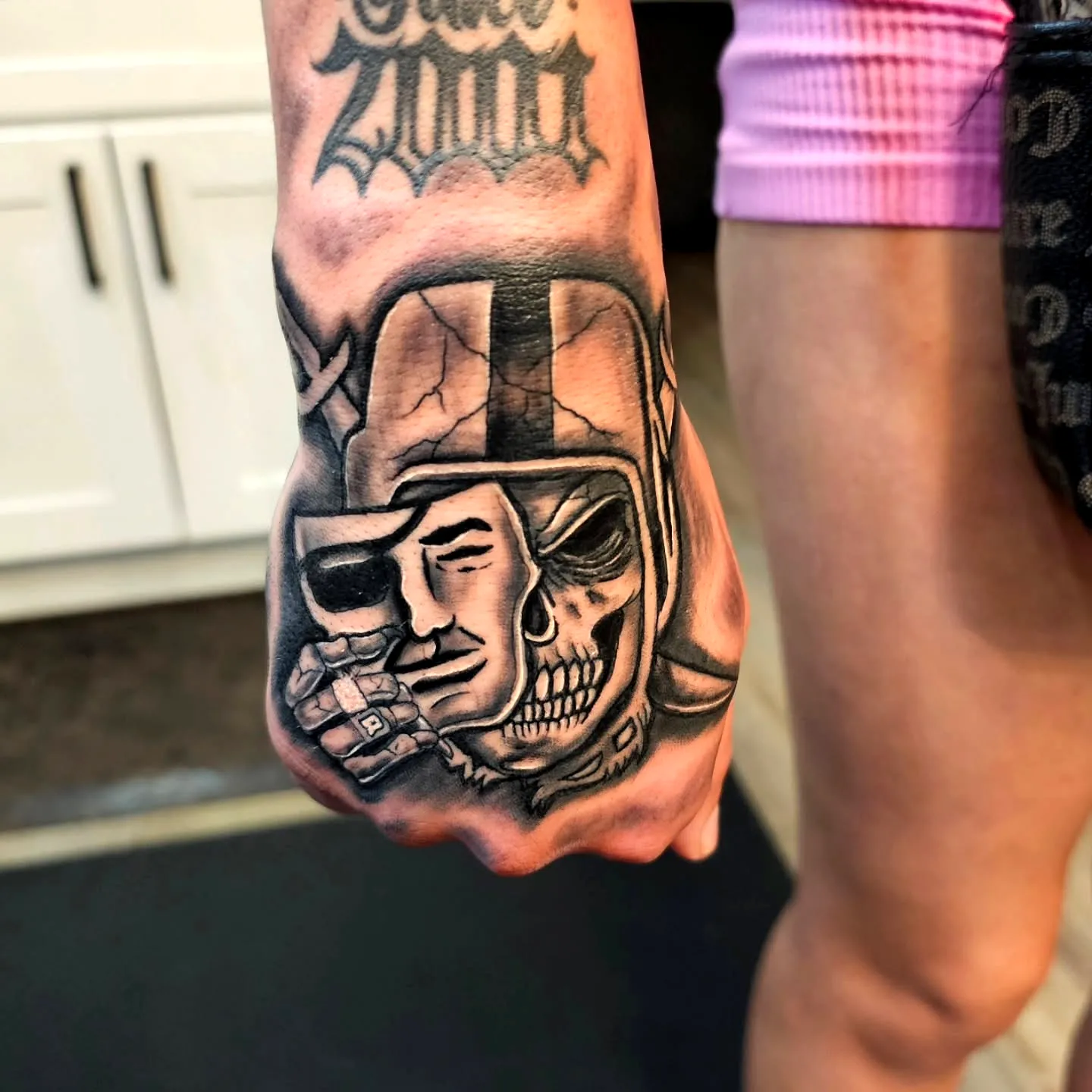 Skull and Face Hand Tattoo Design