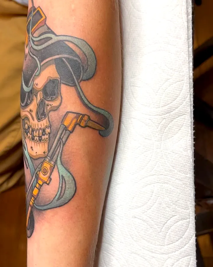 Skull Forearm Tattoo with Revolver Design
