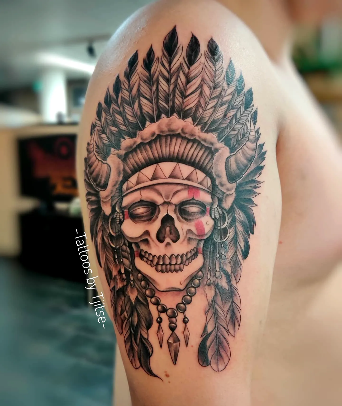 Skull Upper Arm Tattoo with Headdress