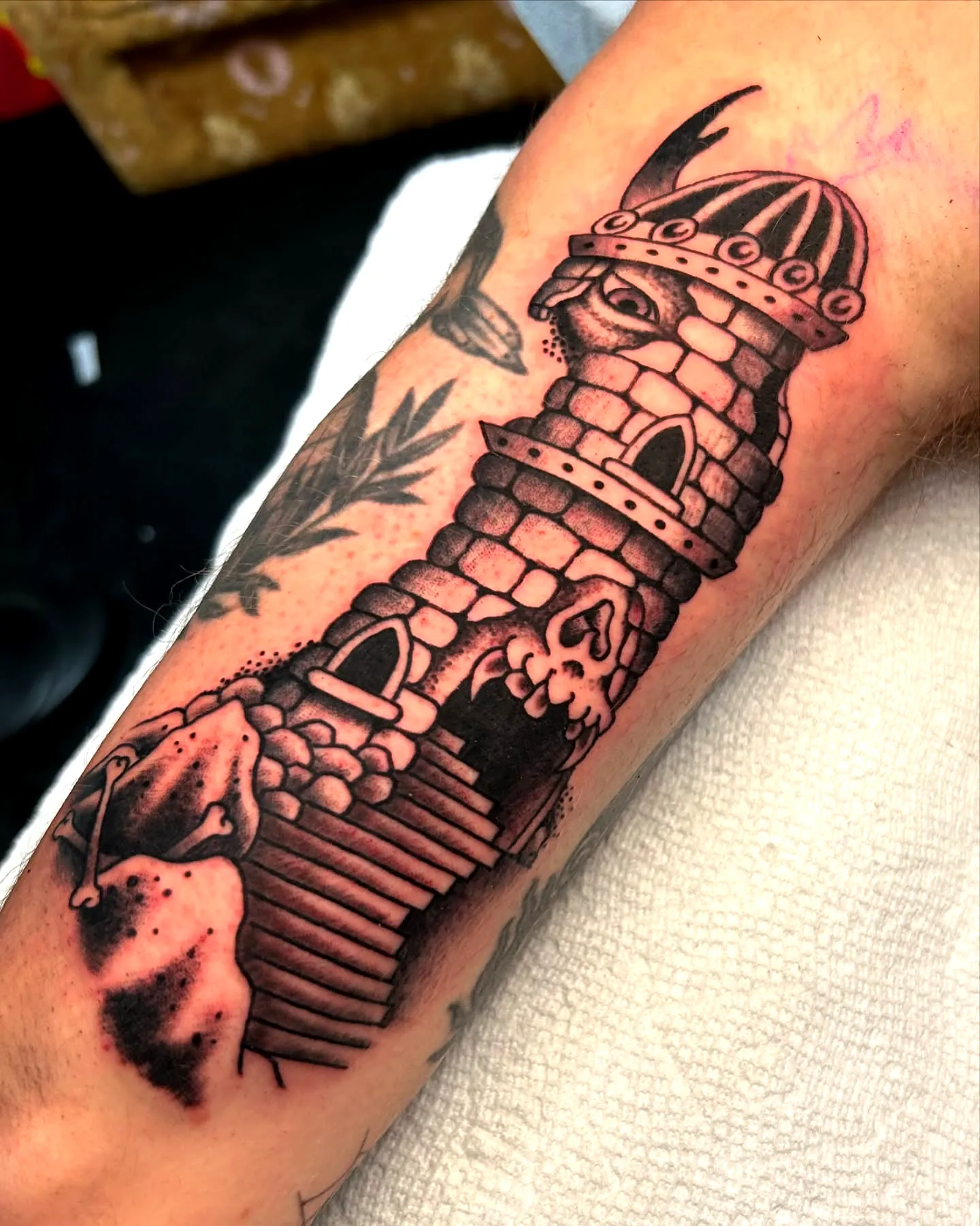 Stone Tower Tricep Tattoo in Black Ink