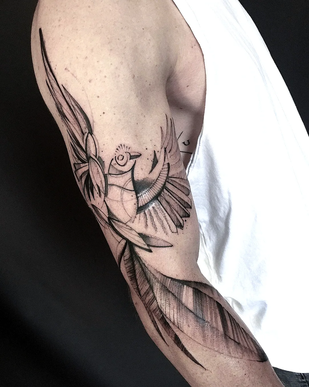 Stylized Bird Upper Arm Tattoo