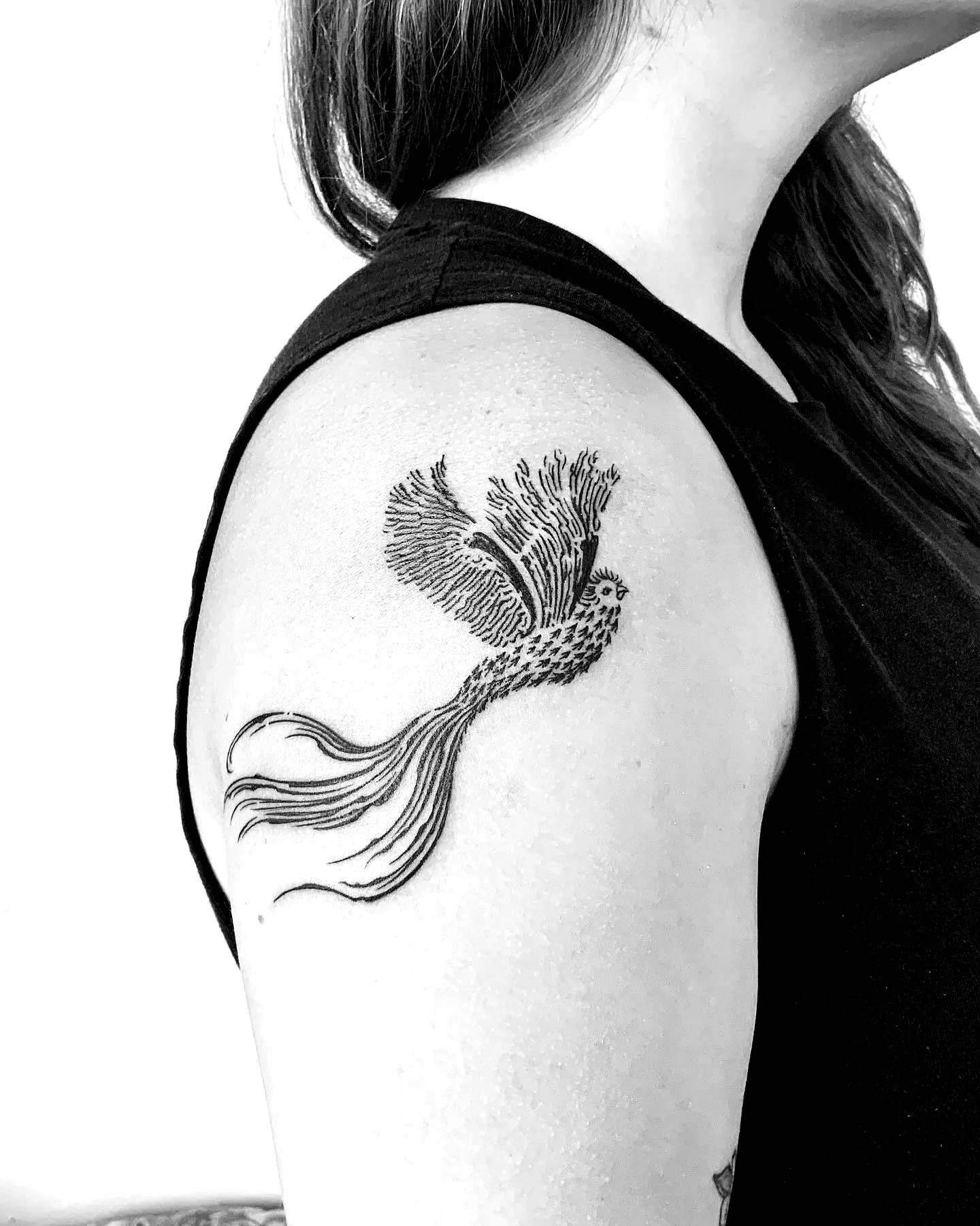 Stylized Bird Upper Arm Tattoo