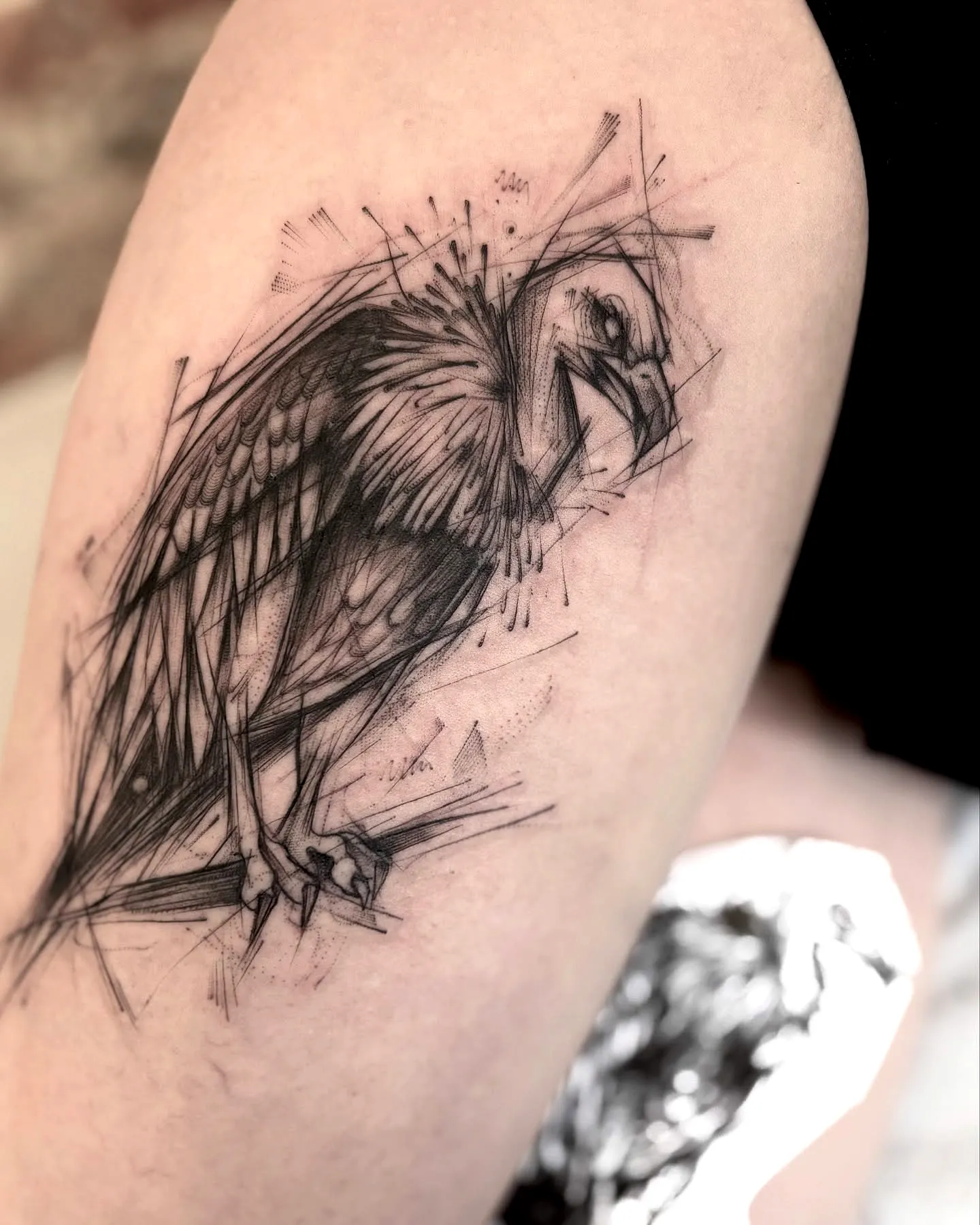 Stylized Bird Upper Arm Tattoo