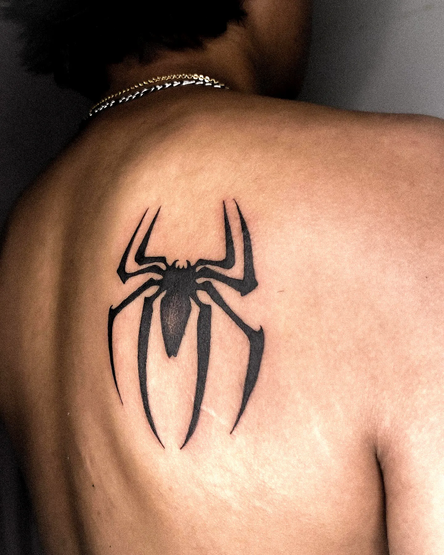 Stylized Black Spider Upper Back Tattoo