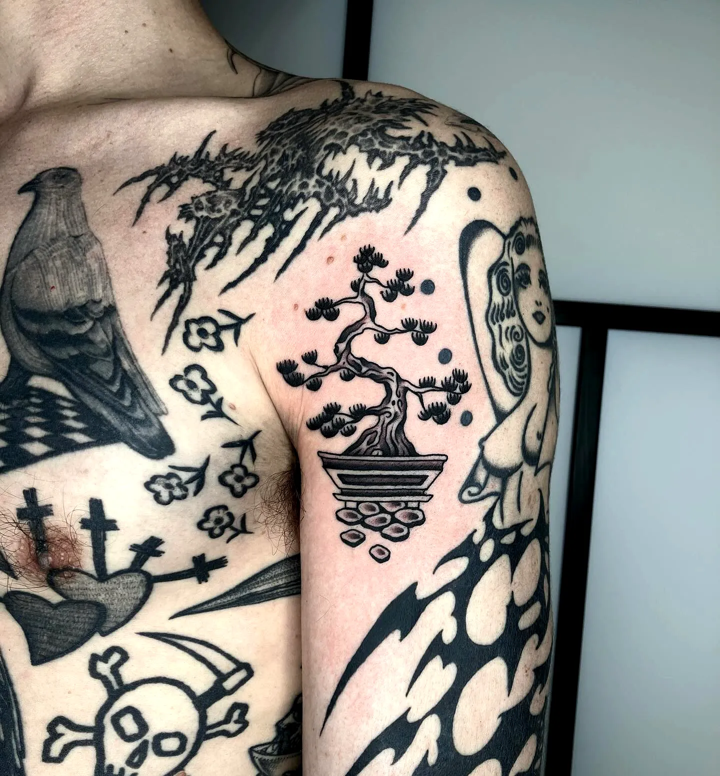 Stylized Bonsai Arm Tattoo in Black Ink