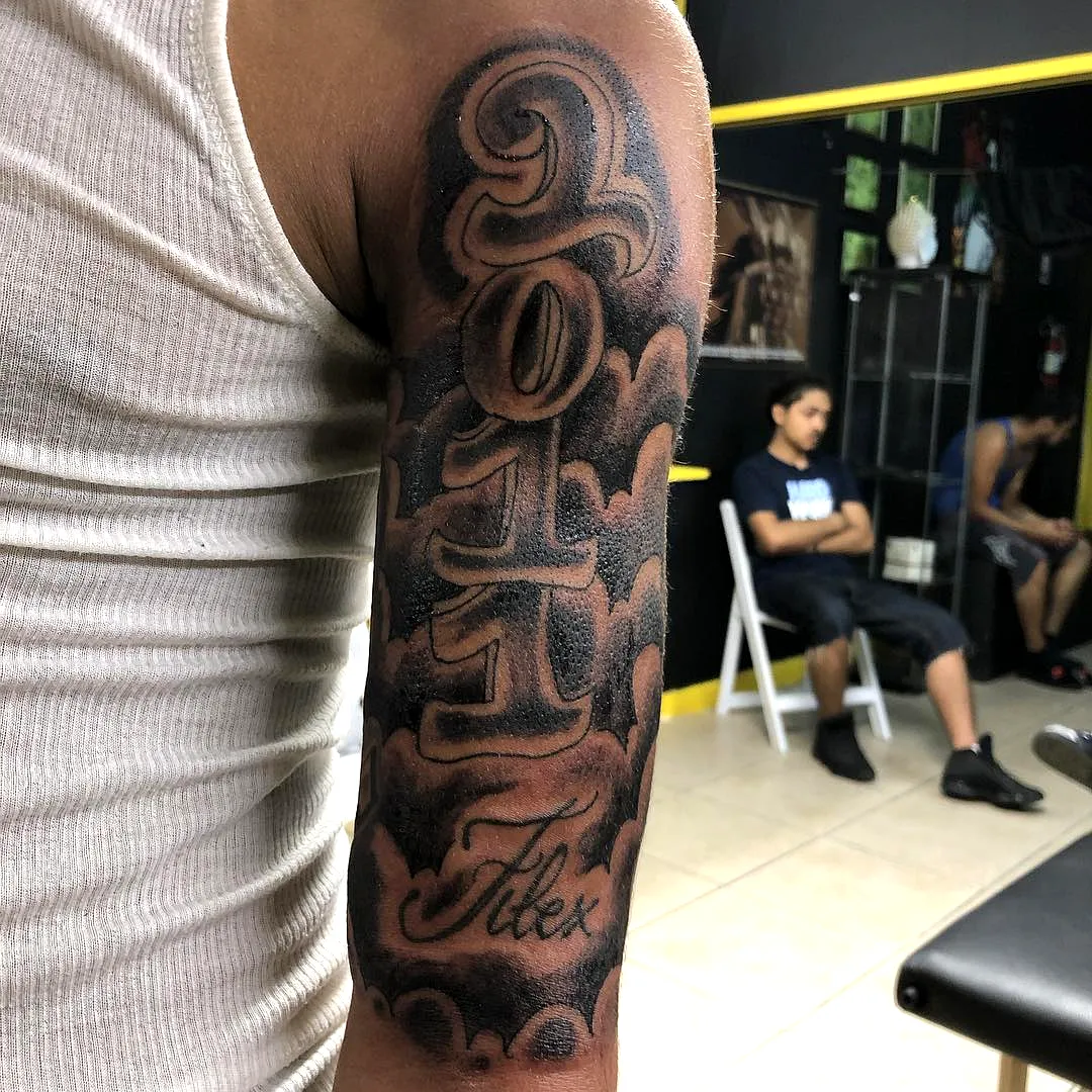 Stylized Calligraphy Forearm Tattoo