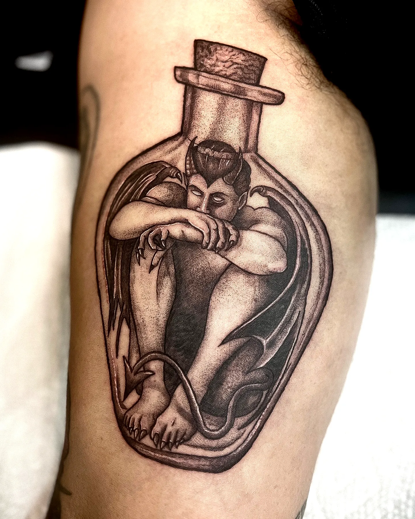 Stylized Devil Arm Tattoo in Black and Gray