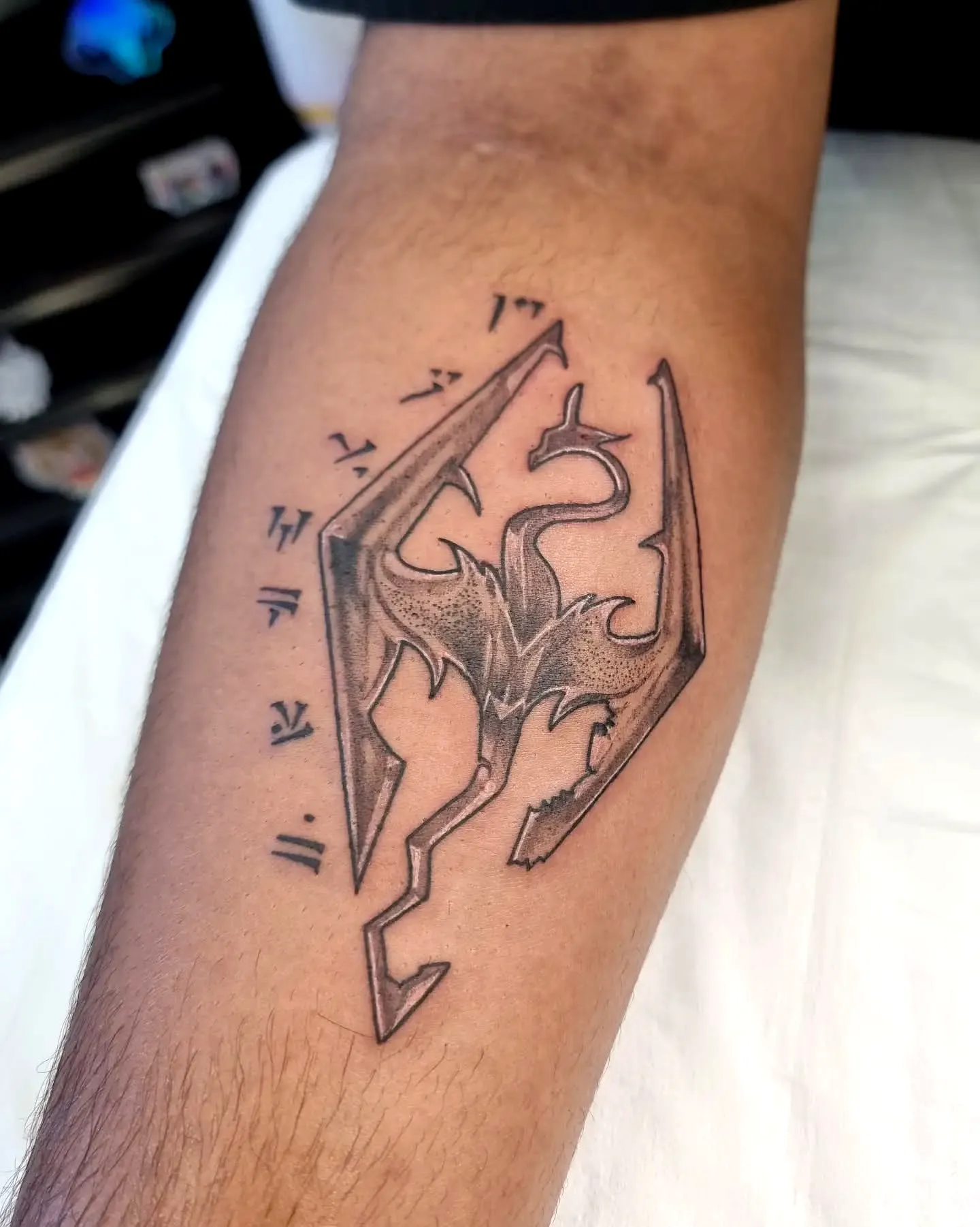 Stylized Dragon Forearm Tattoo