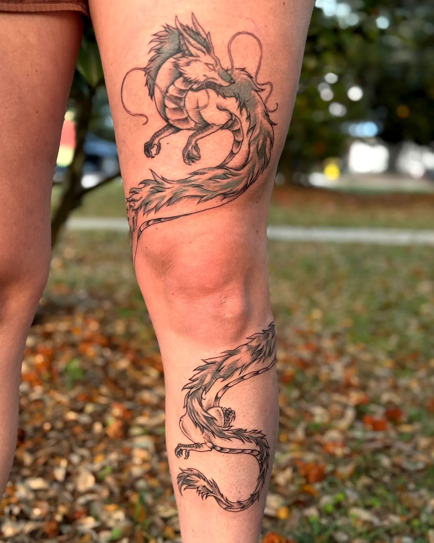Stylized Dragon Leg Tattoo in Black