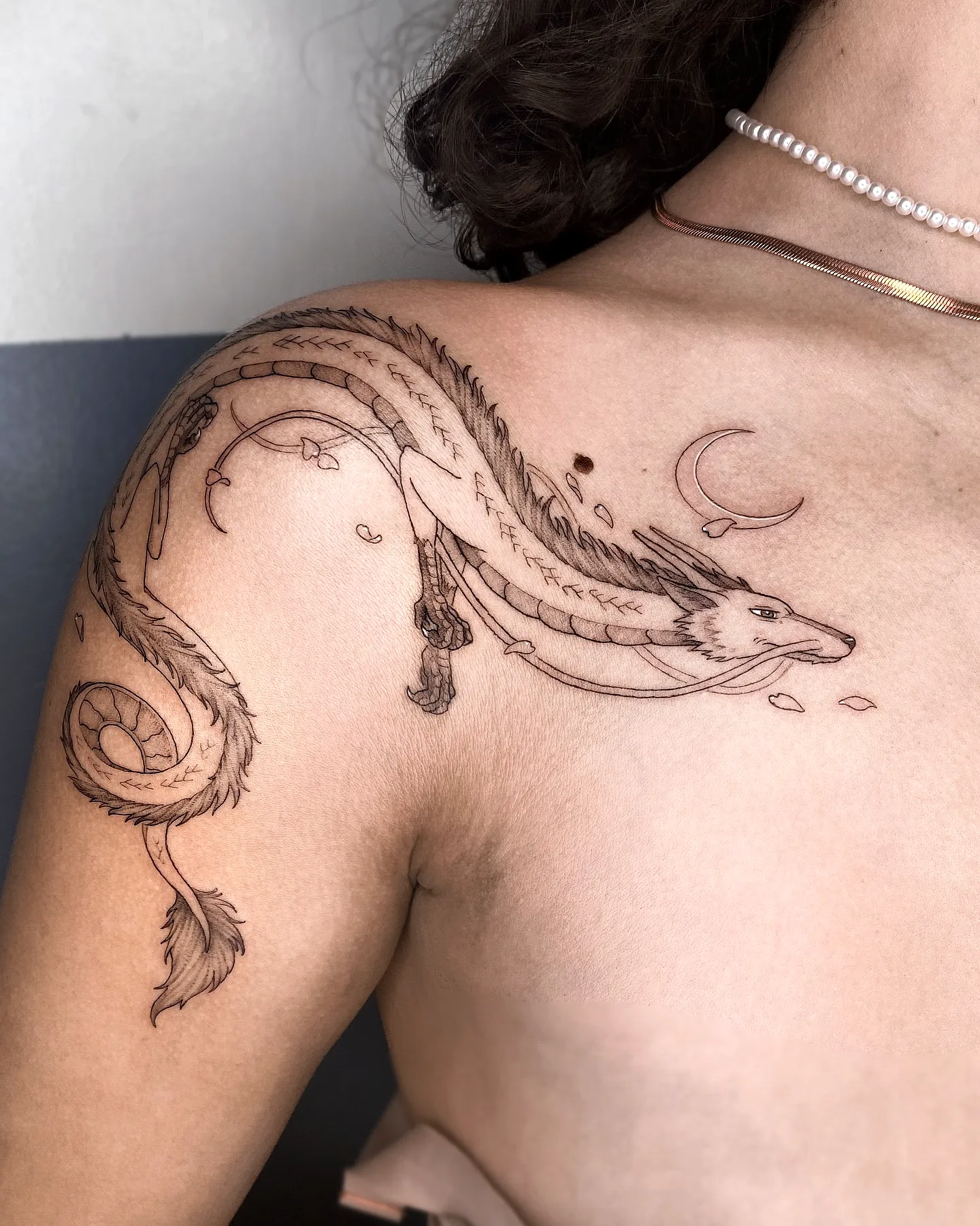 Stylized Dragon Shoulder Tattoo with Moon