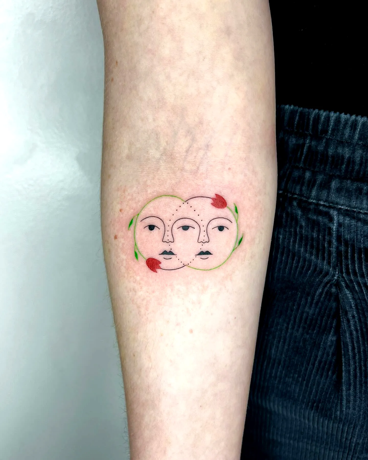 Stylized Faces Forearm Tattoo with Rose