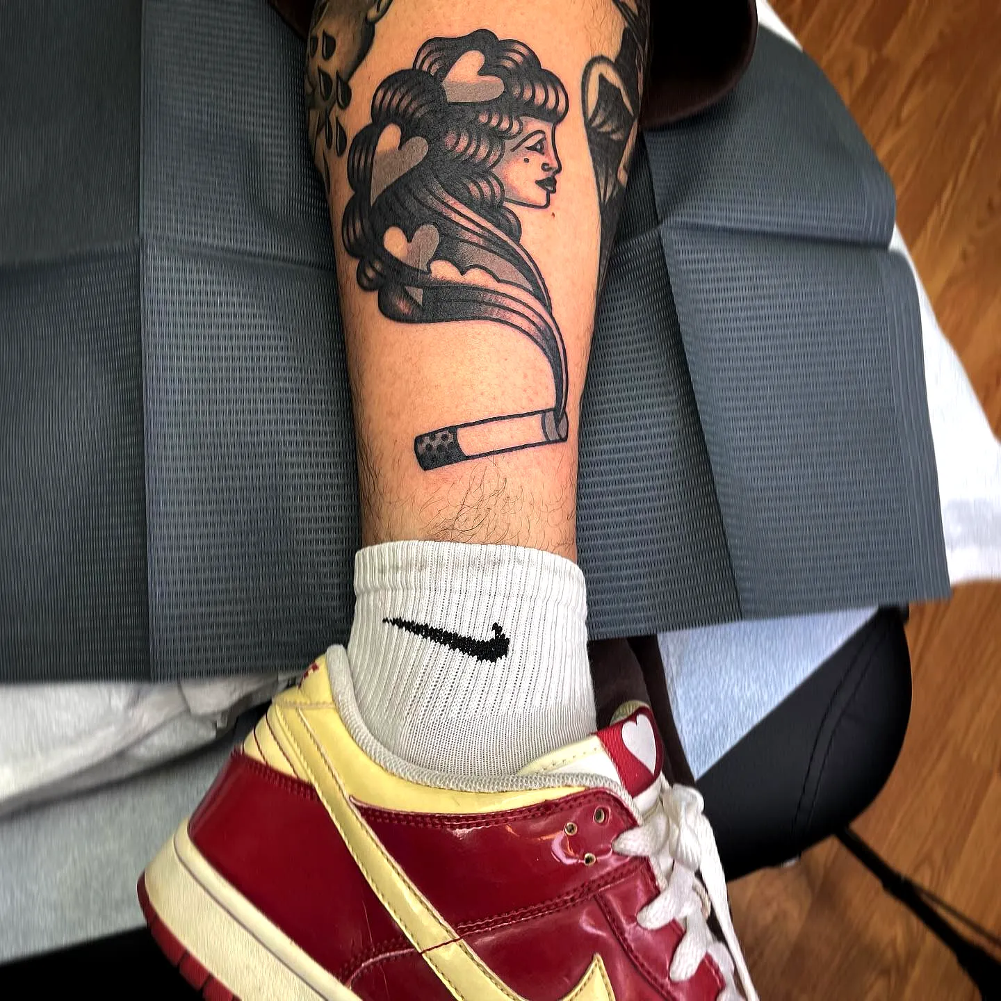 Stylized Female Face Lower Leg Tattoo