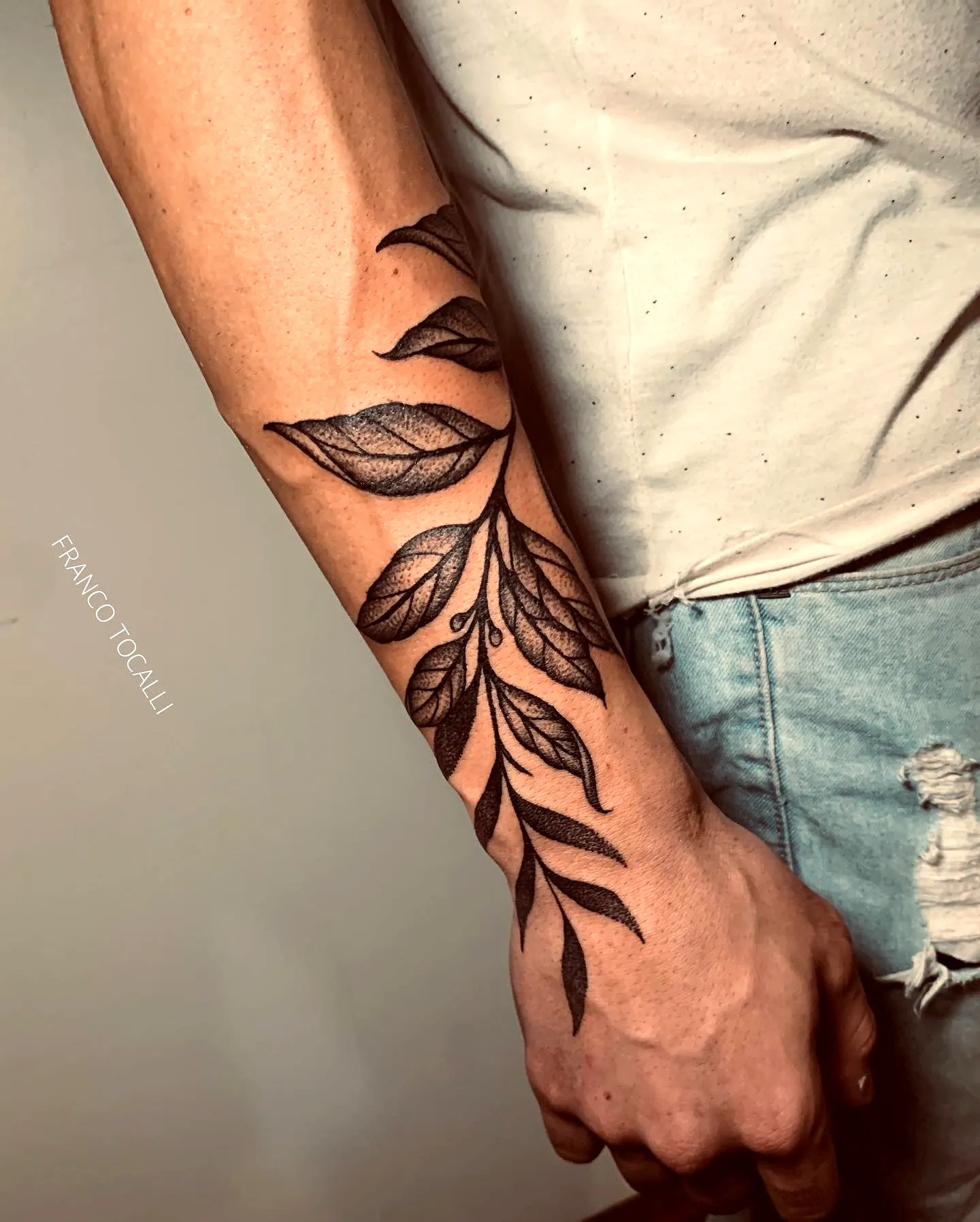 Stylized Laureles Forearm Tattoo