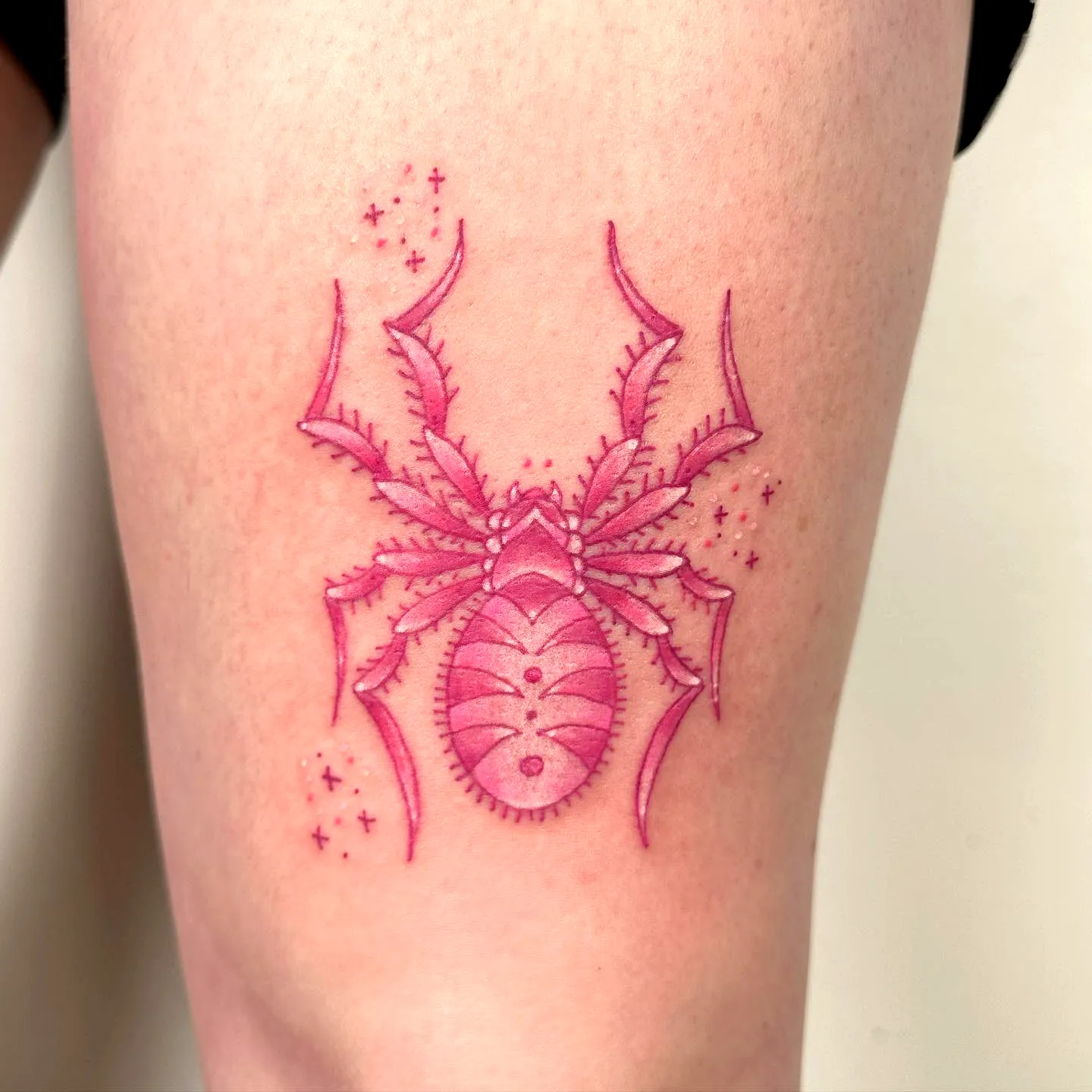 Stylized Pink Spider Thigh Tattoo