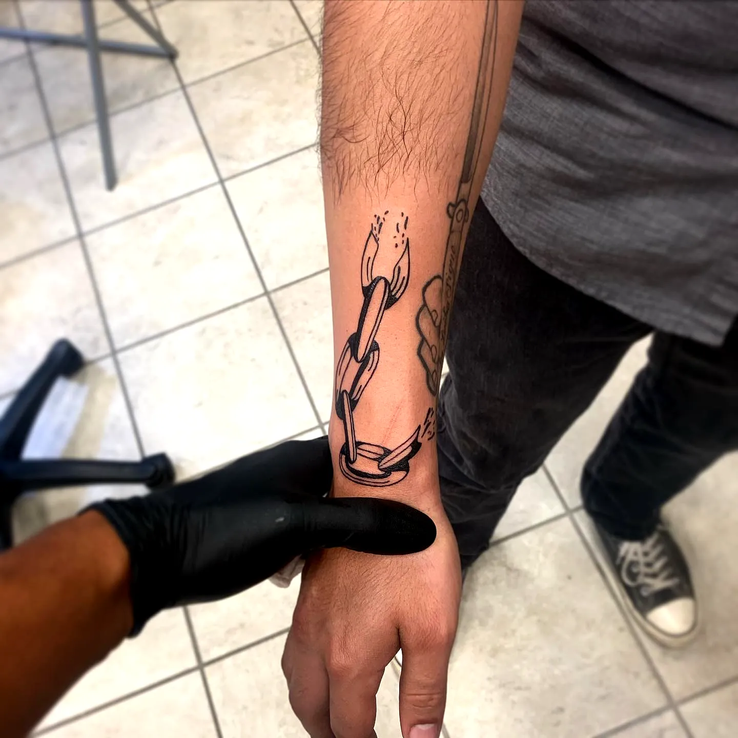 Stylized Shackle Forearm Tattoo