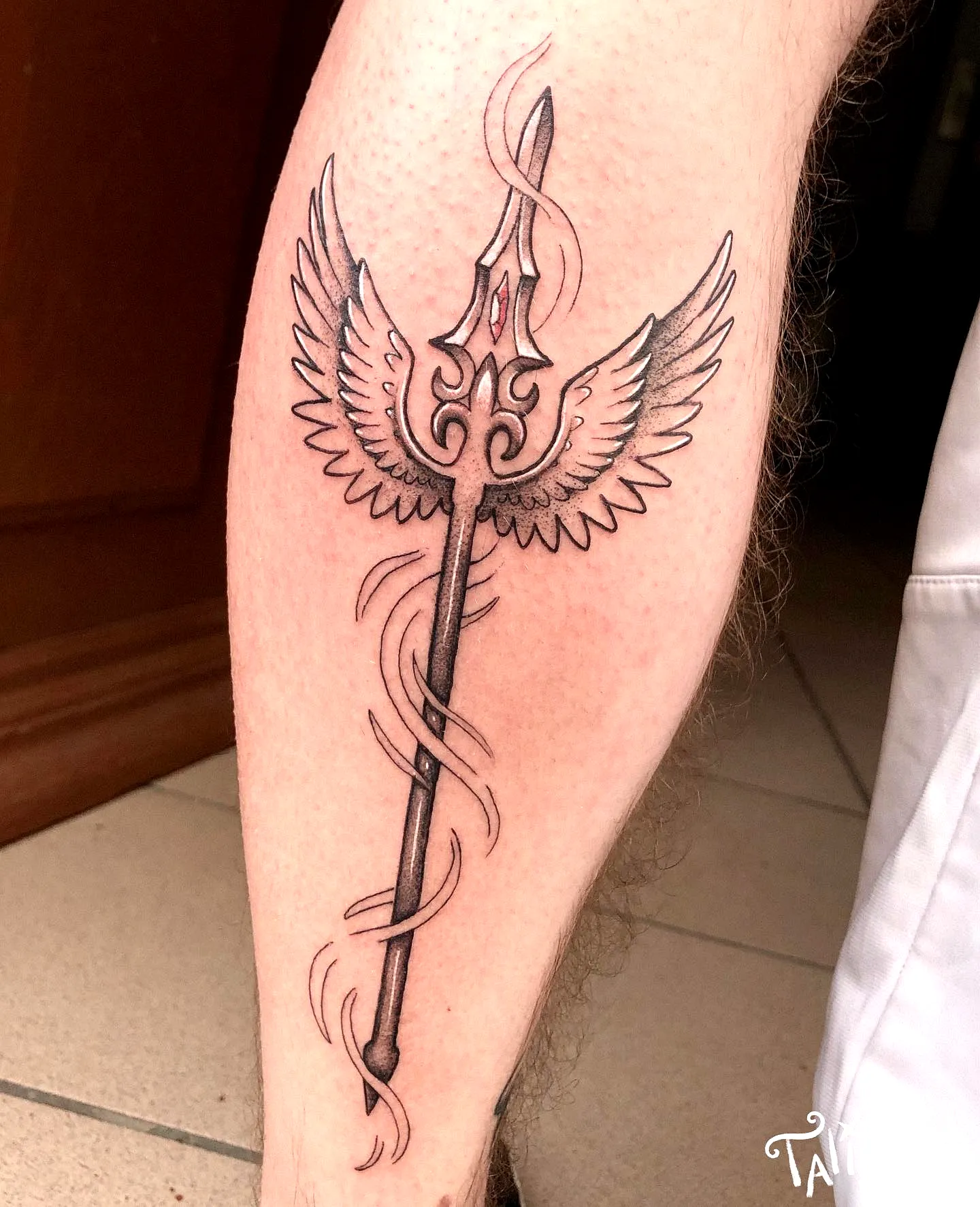 Stylized Spear Calf Tattoo with Wings