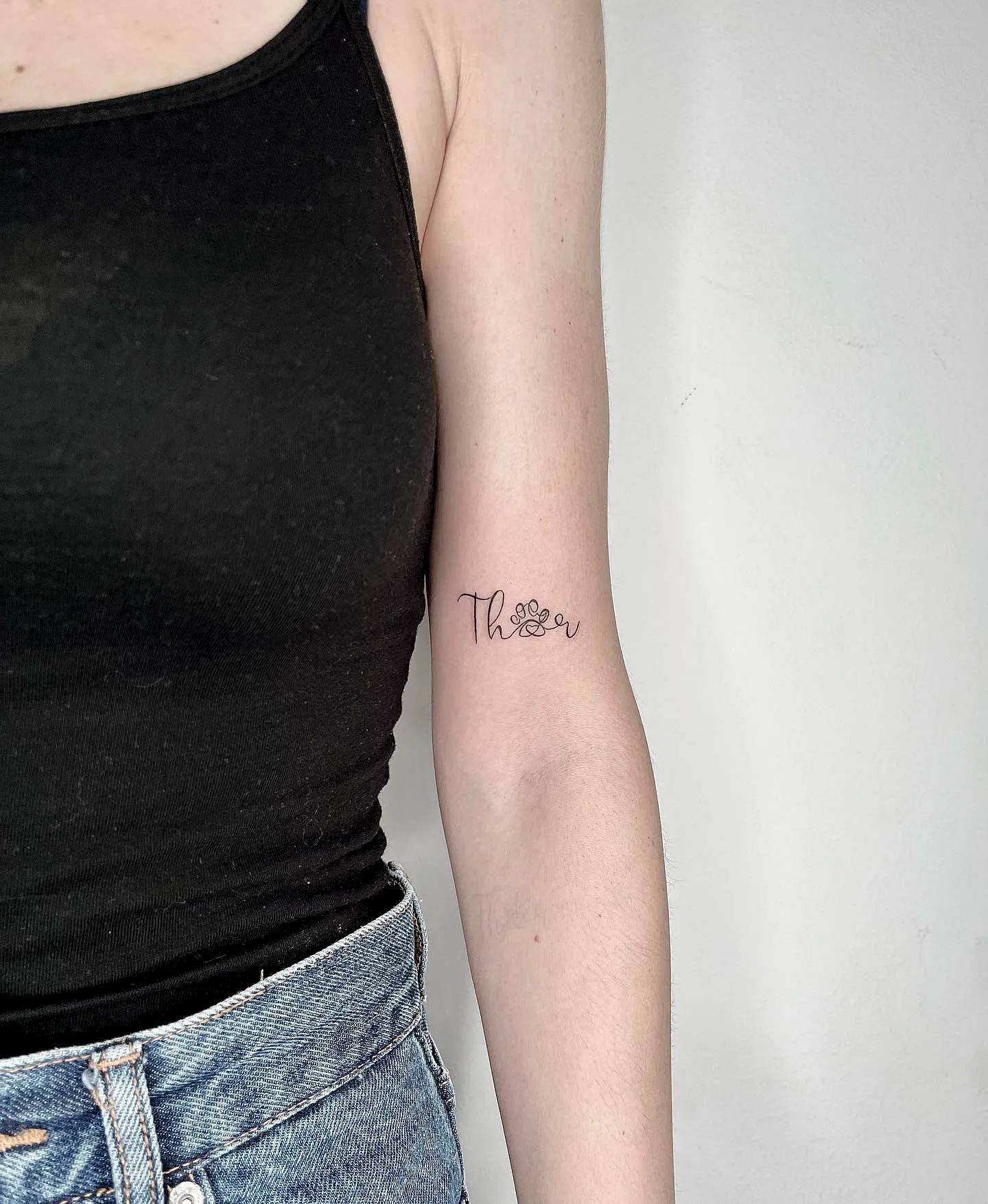 Stylized Thor Upper Arm Tattoo with Floral Element