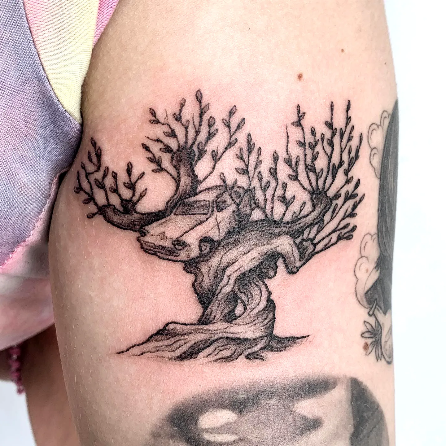 Stylized Tree Arm Tattoo in Black Ink