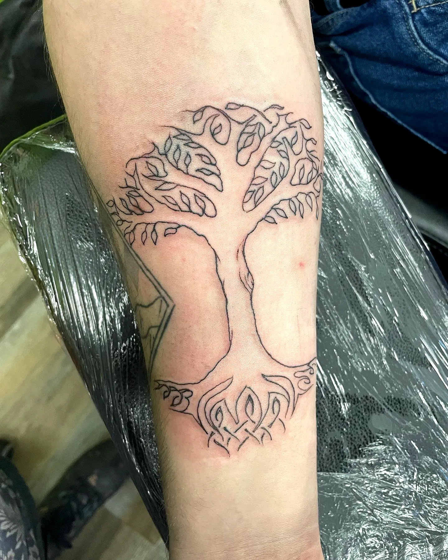 Stylized Tree Forearm Tattoo in Black Ink
