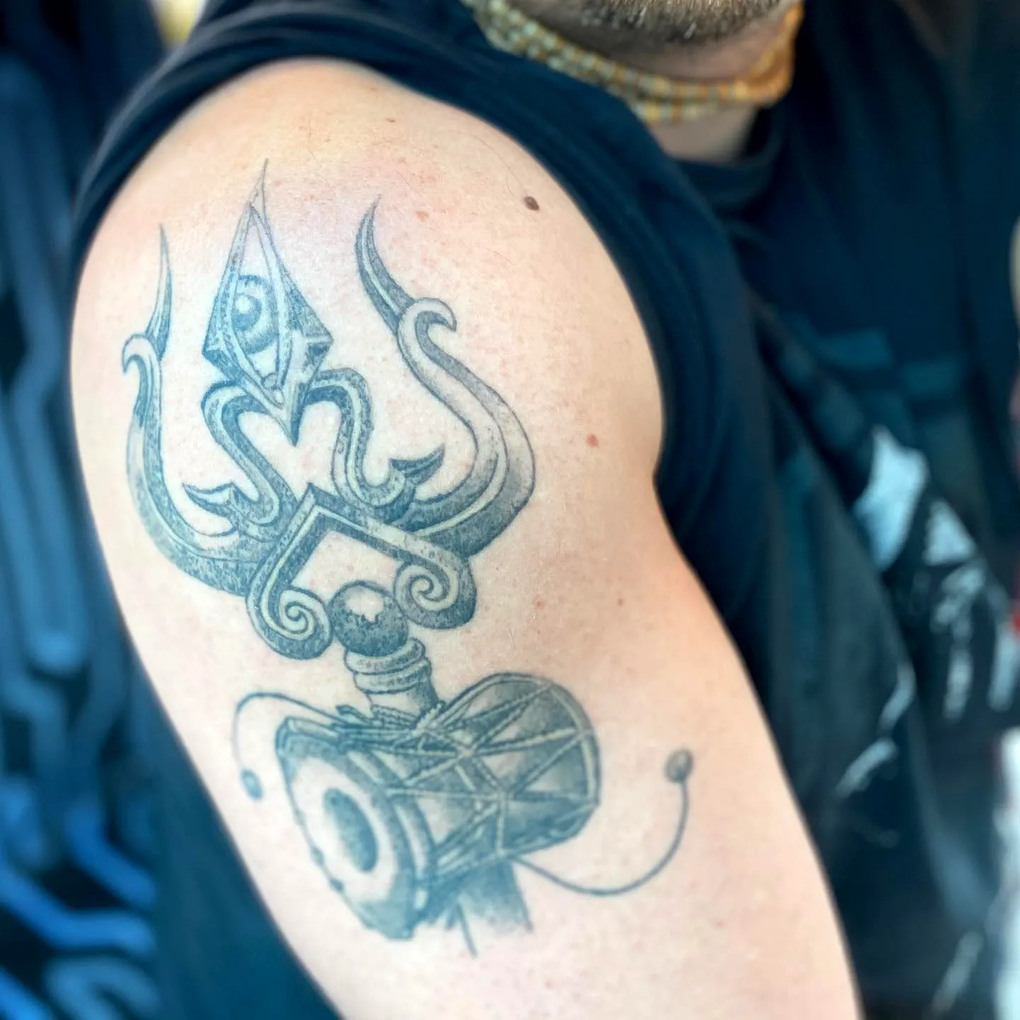 Stylized Trident Upper Arm Tattoo