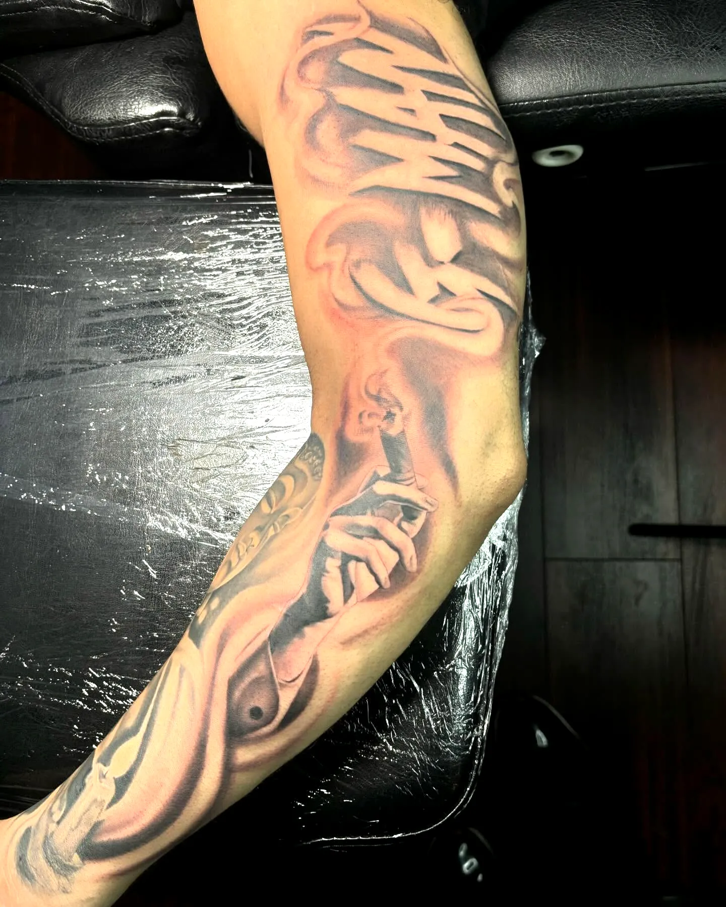 Surrealistic Forearm Tattoo in Gray Black