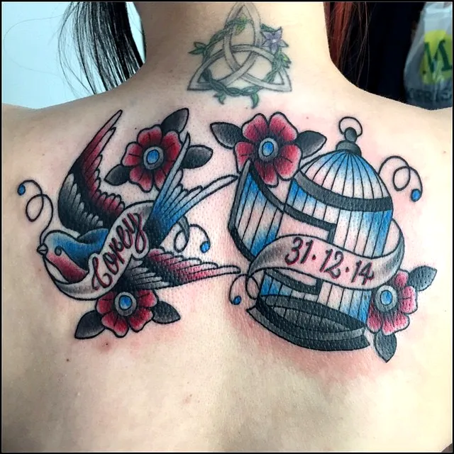 Vibrant Birdcage Upper Back Tattoo