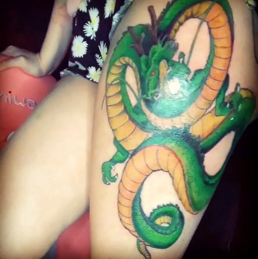 Vibrant Dragon Thigh Tattoo Design
